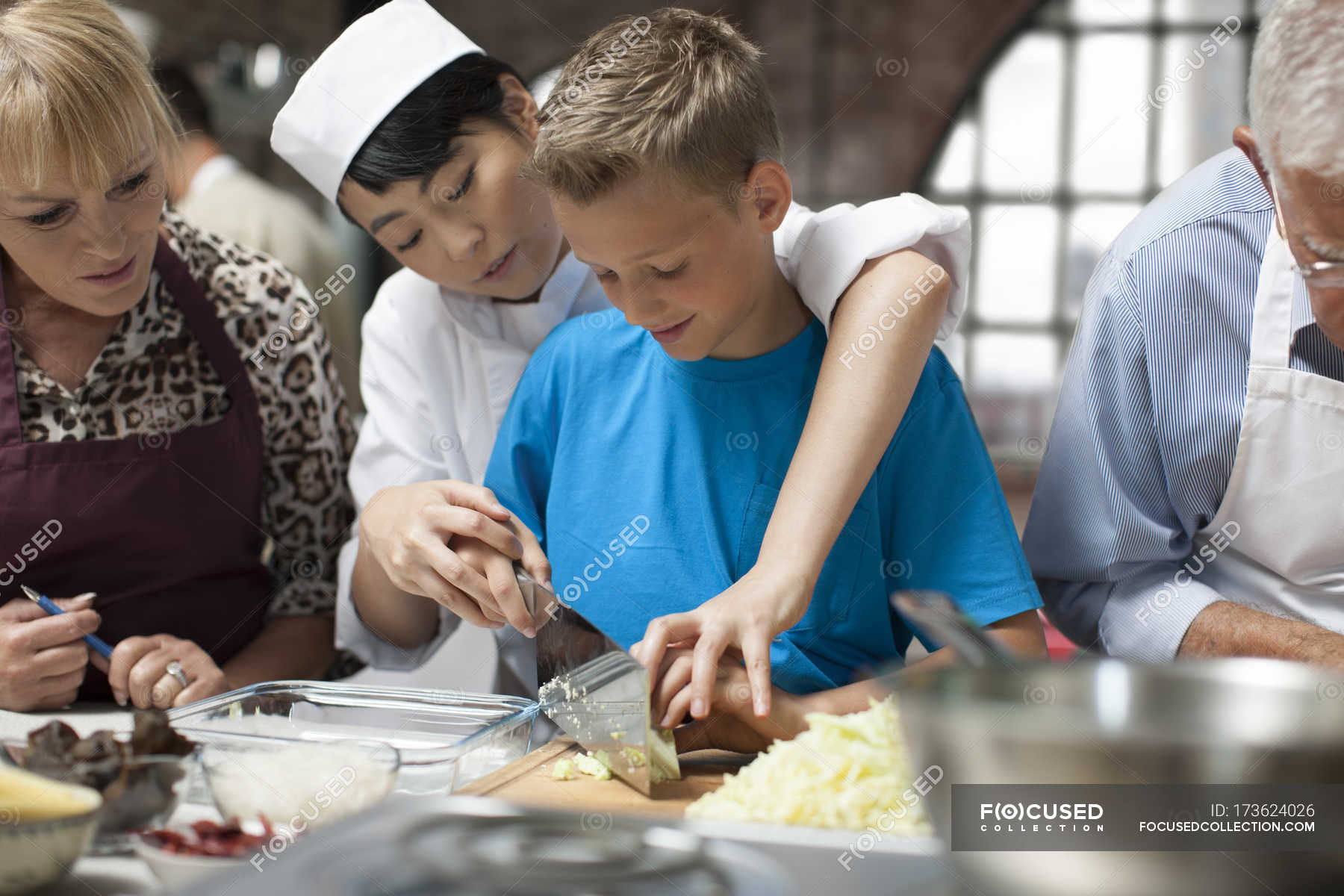 Happy cute siblings cooking in kitchen — learning, teamwork Stock
