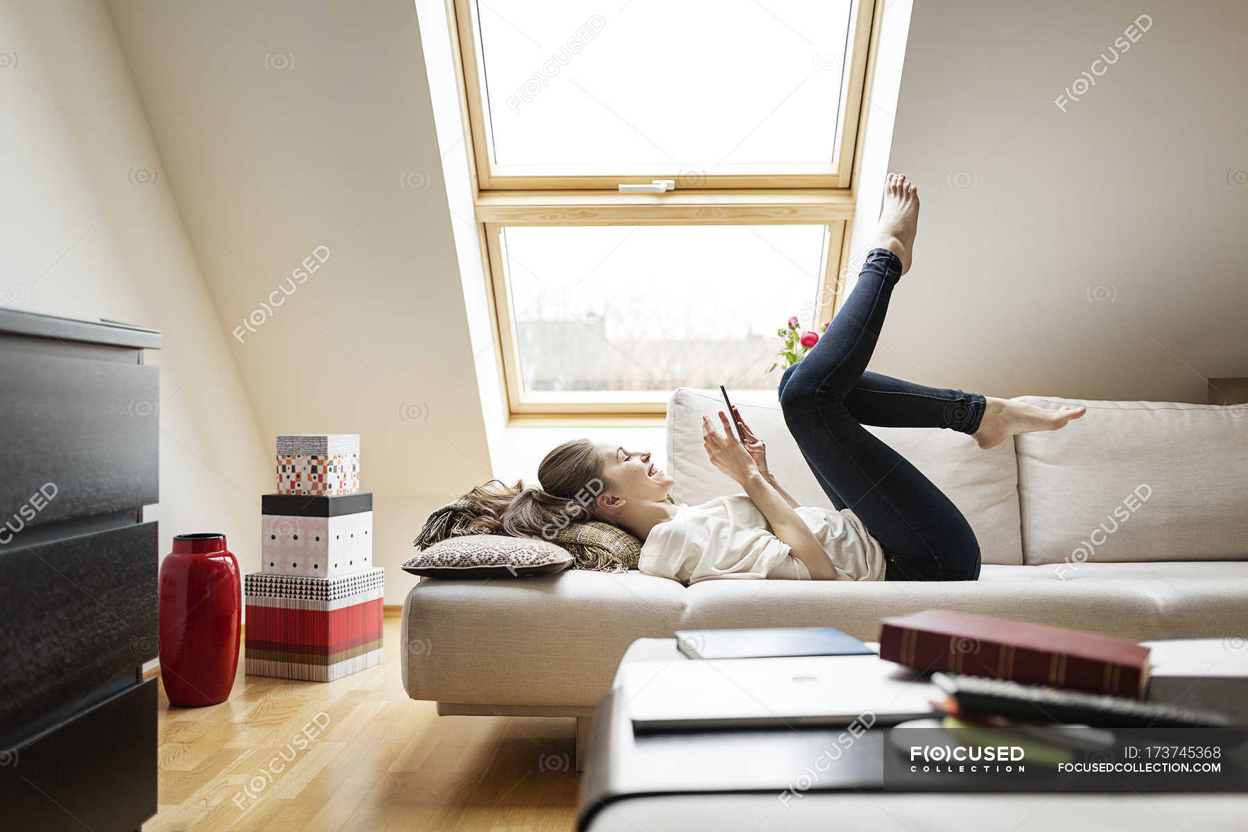 https://st.focusedcollection.com/14026668/i/1800/focused_173745368-stock-photo-happy-woman-lying-on-couch.jpg