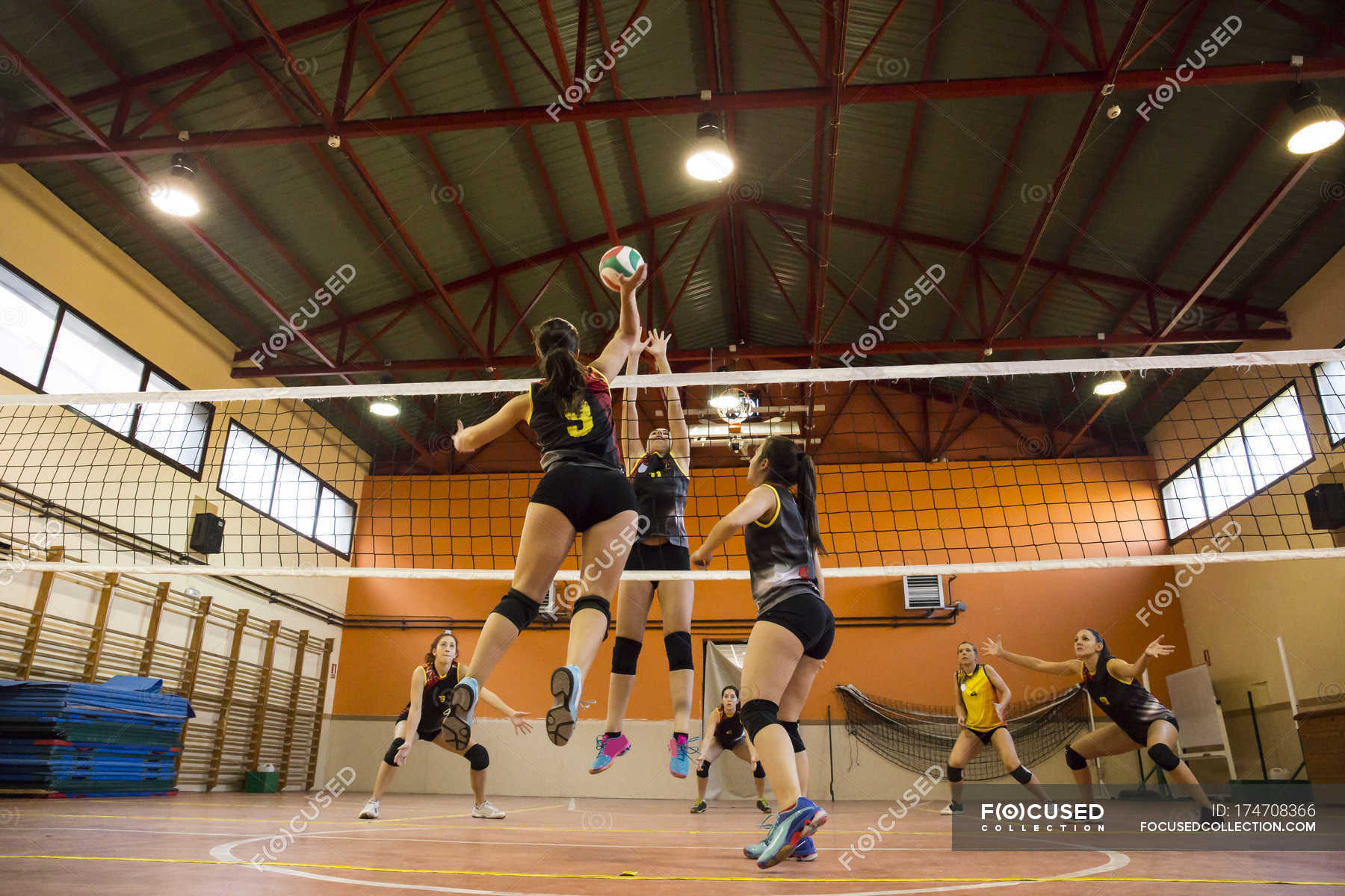 Volleyball player spiking the ball during a volleyball match — Stock