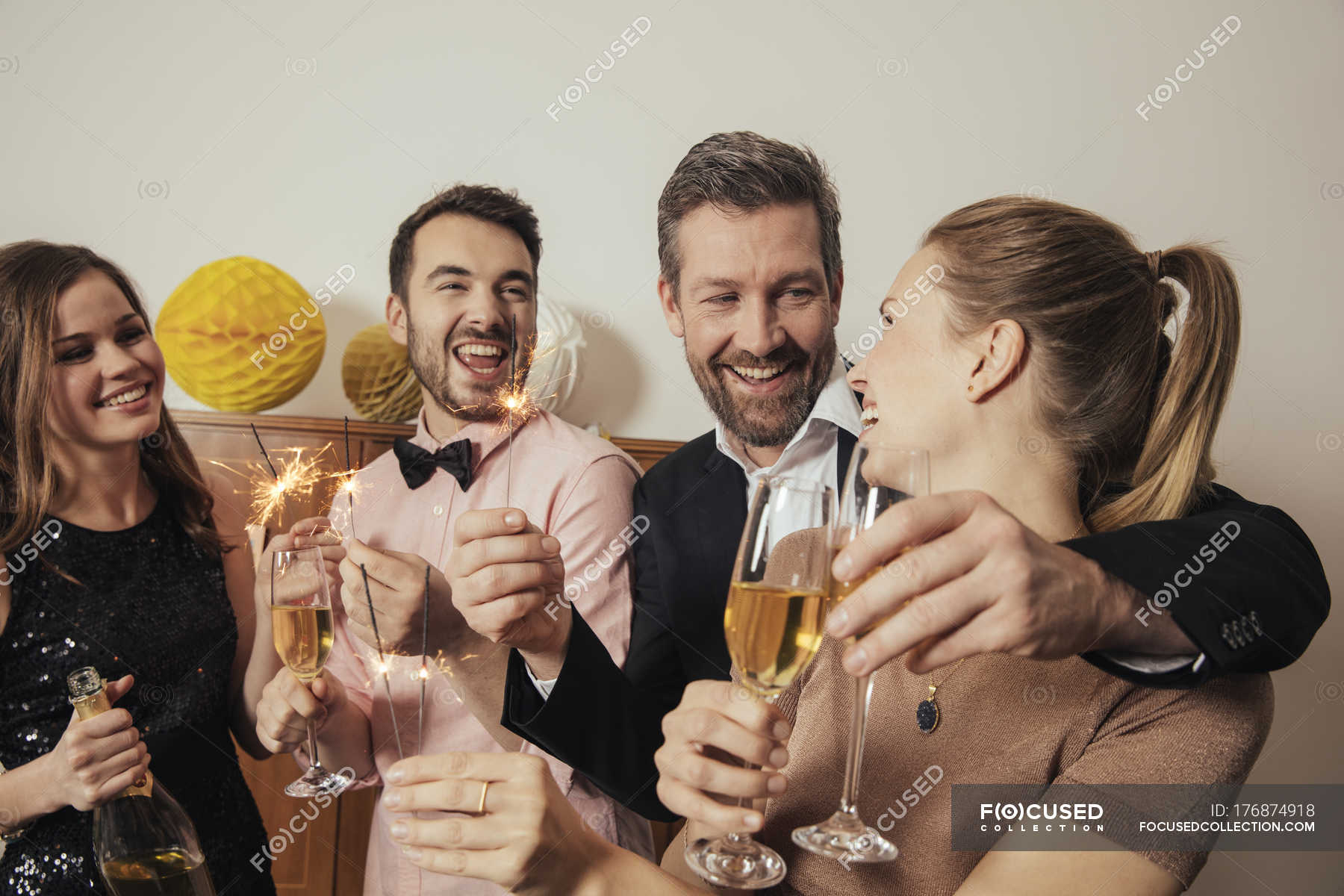 Friends celebrating New Year's Eve together, drinking champagne — Mid