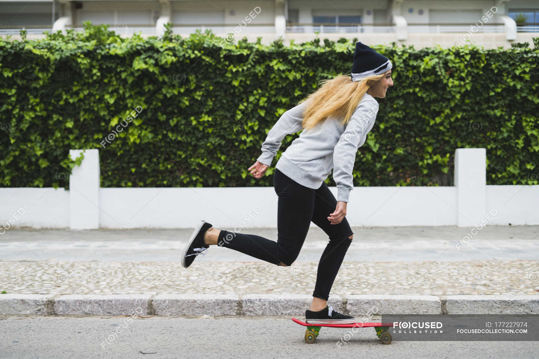 Young stylish woman skateboarding street — daytime, hobby - Stock Photo #177227974