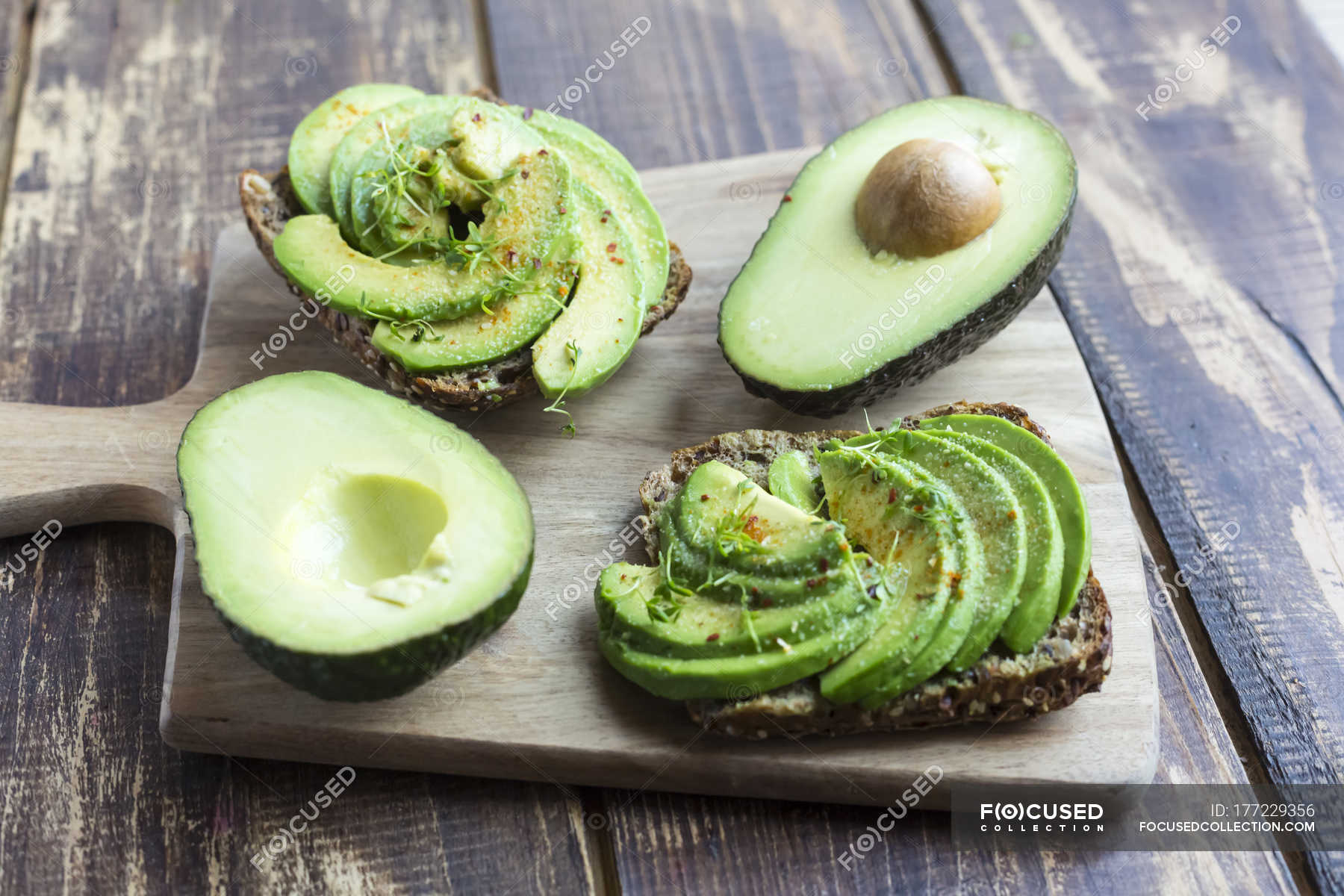Protein bread garnished with sliced avocado, cress and chili powder