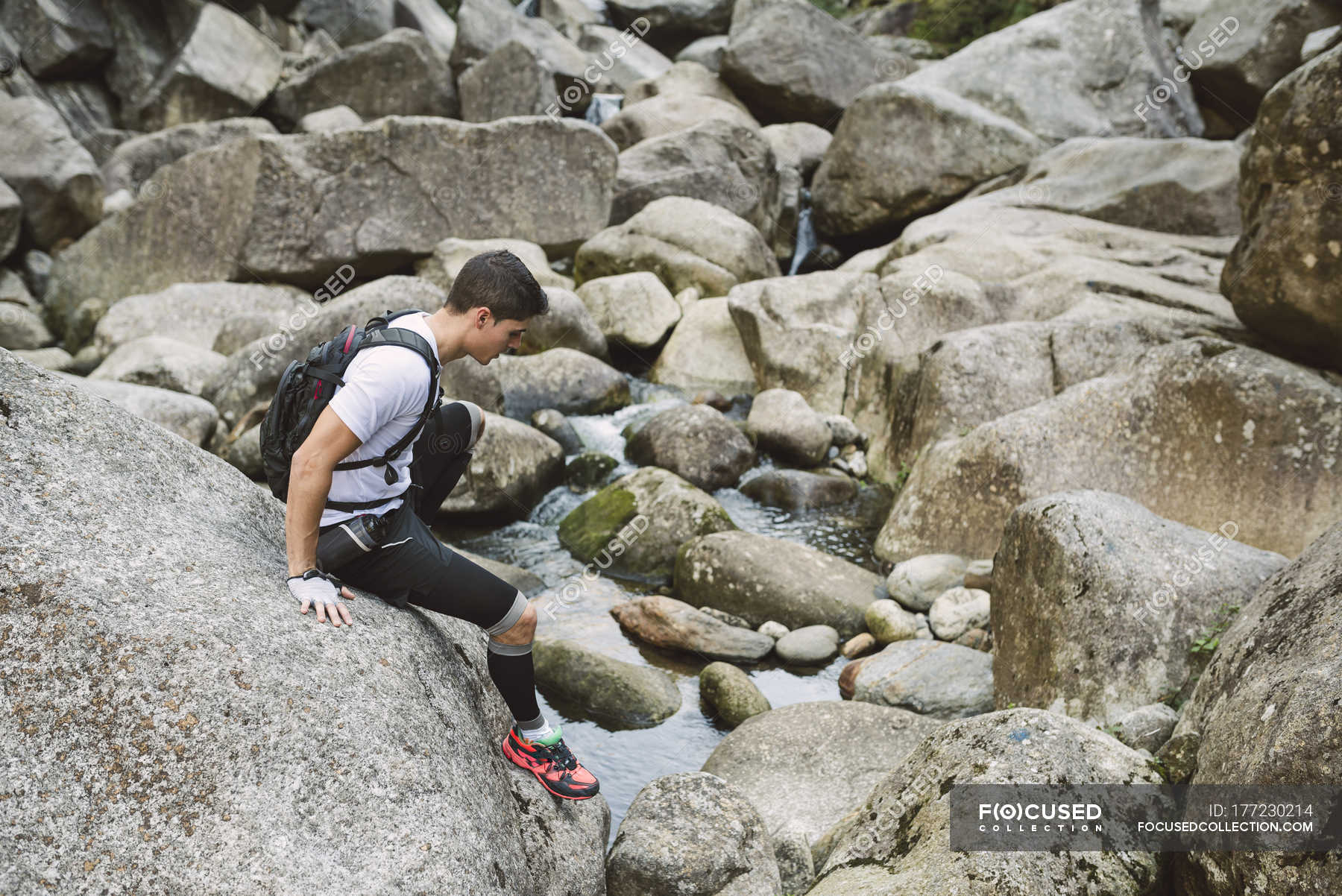 Ultra trail runner climbing on rocks — Galicia, young man Stock Photo