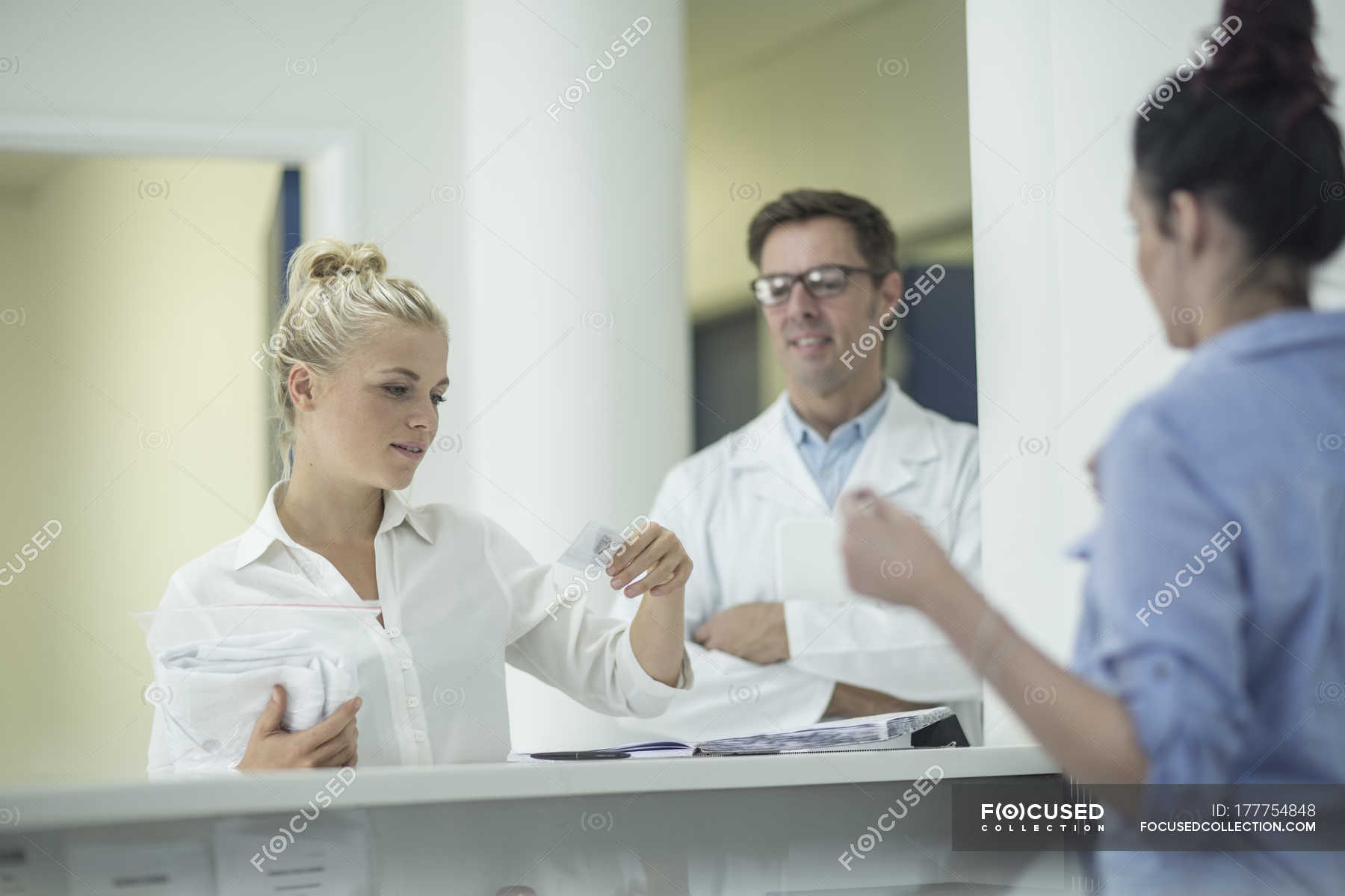 Woman receiving name tag at reception research small group of people 