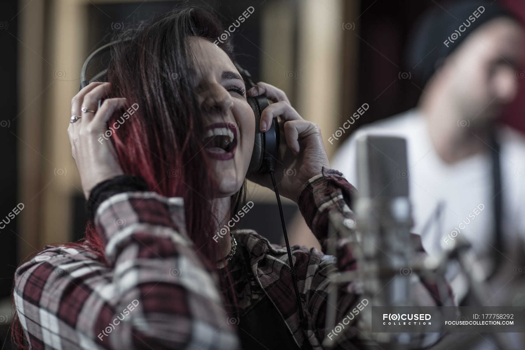 beautiful-female-singer-with-red-hair-at-recording-studio-indoors