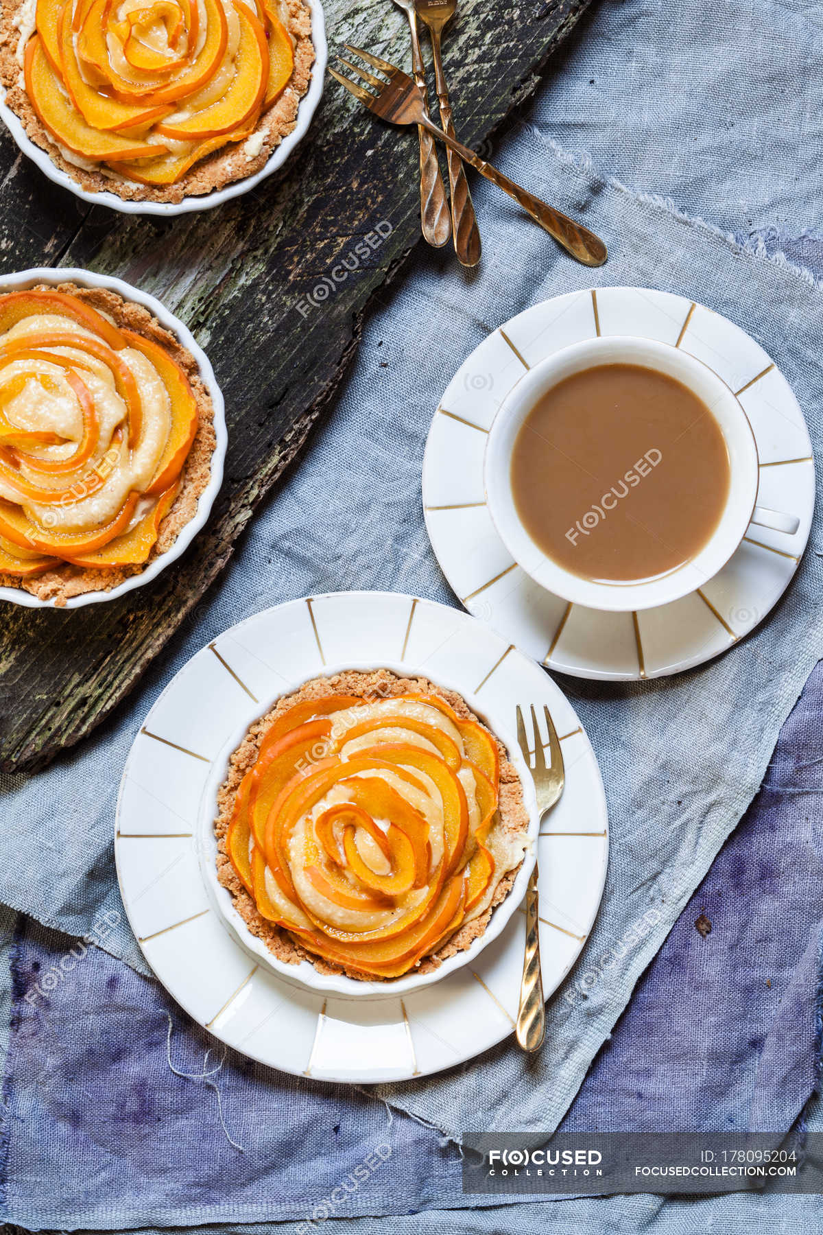 Almond pies with kaki slices and cup of white coffee — Studio Shot ...
