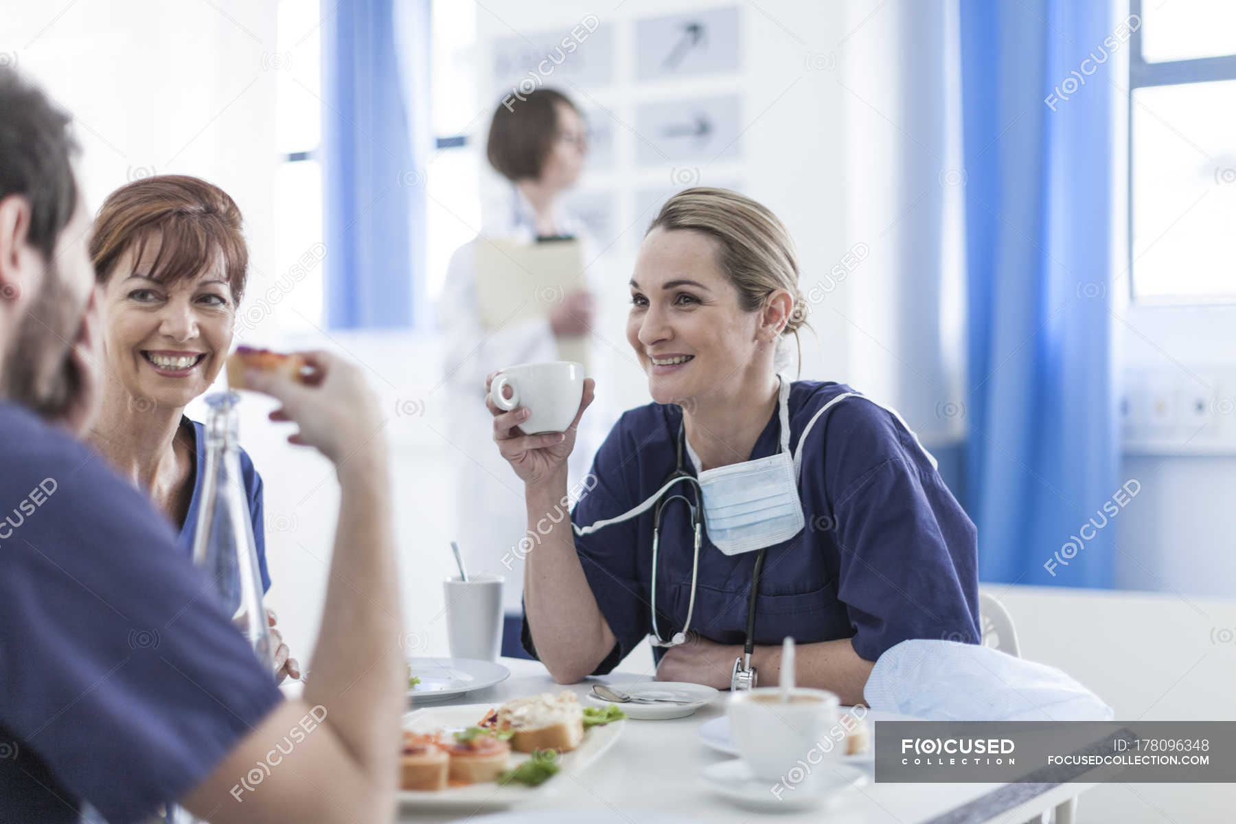 Smiling doctors having breakfast in hospital — people, Caucasian