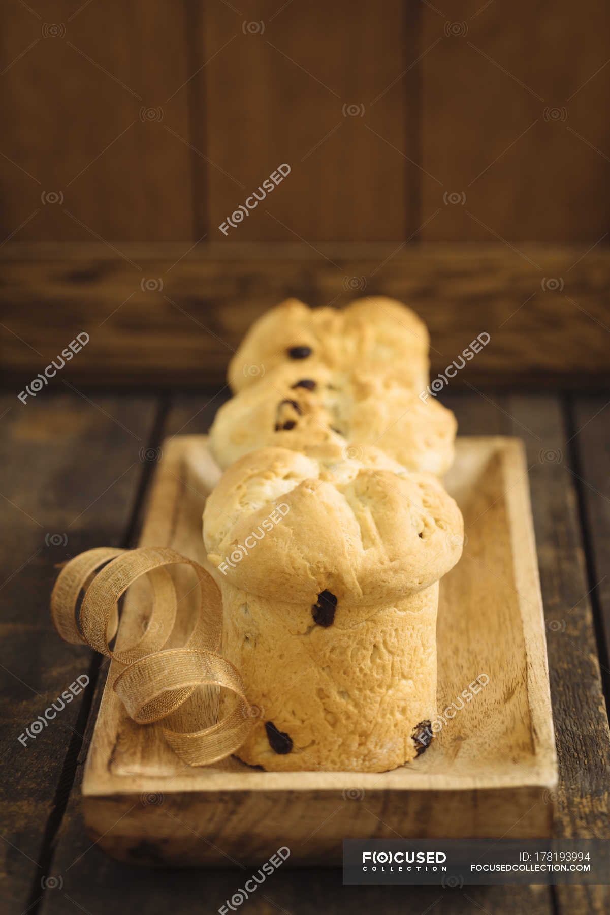 Home-baked mini panettone cakes on wooden tray — holiday, selective ...