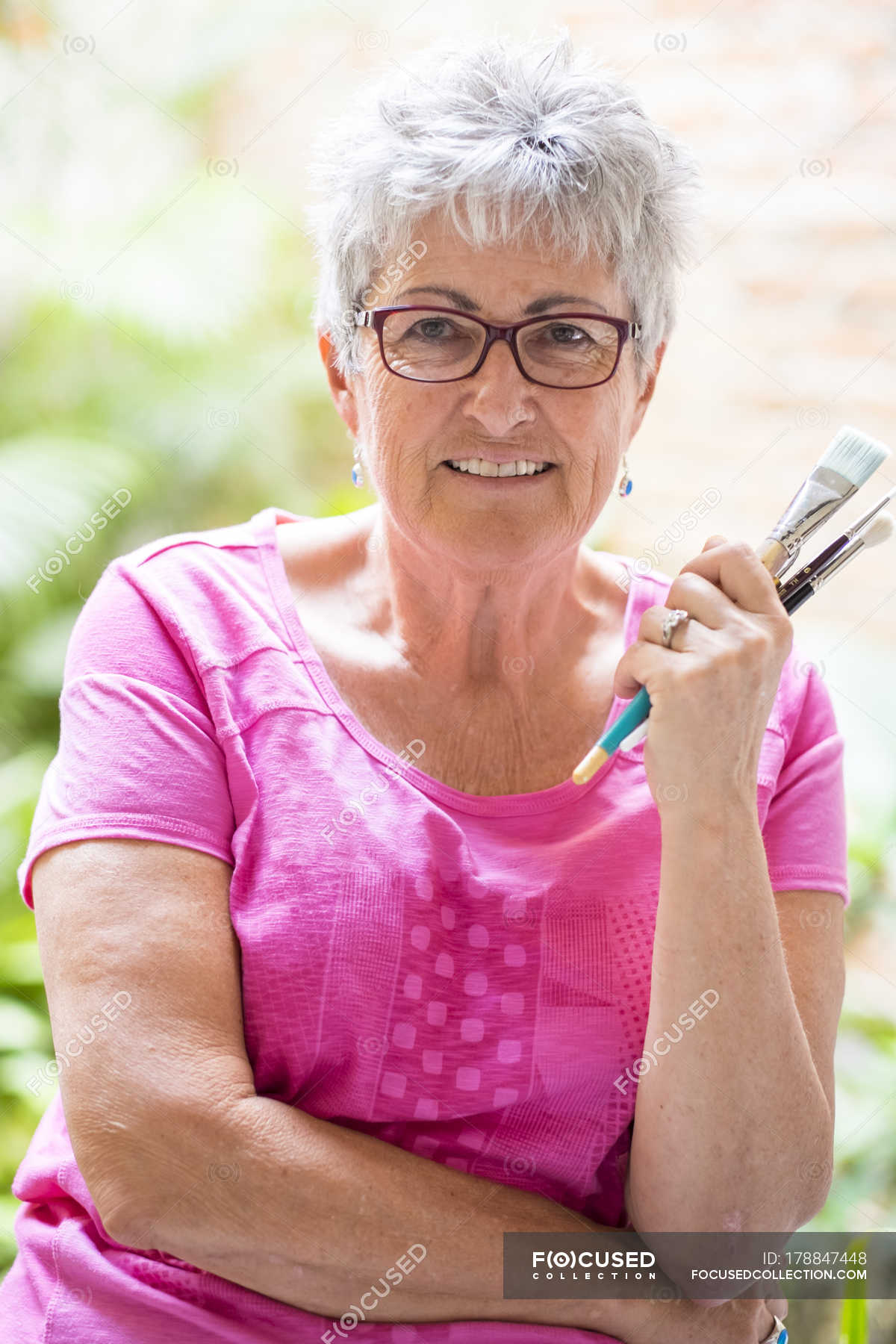 portrait-of-senior-female-painter-creativity-leisure-stock-photo