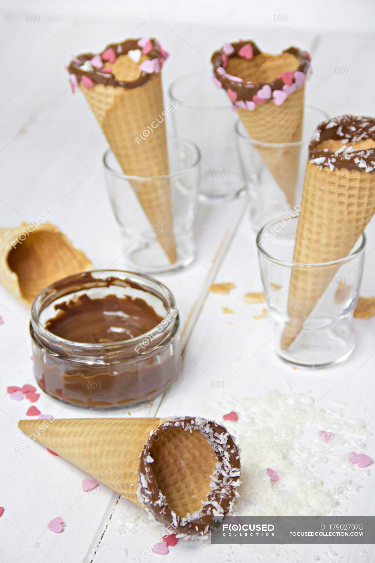 Icecream cones with chocolate, coconut flakes and sugar hearts — heart