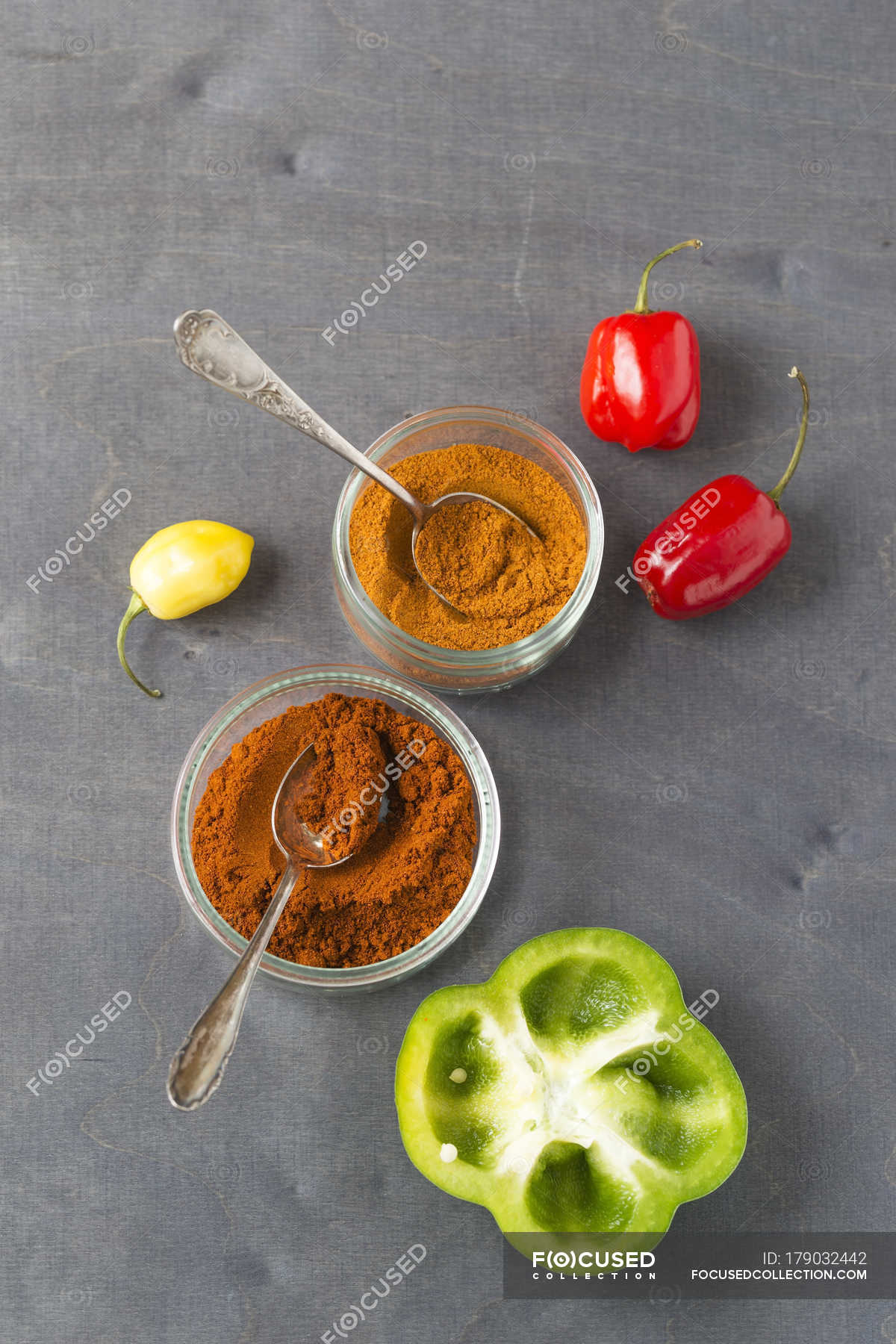 Paprika and chili powder on grey surface — indoor, chili pod Stock Photo 179032442