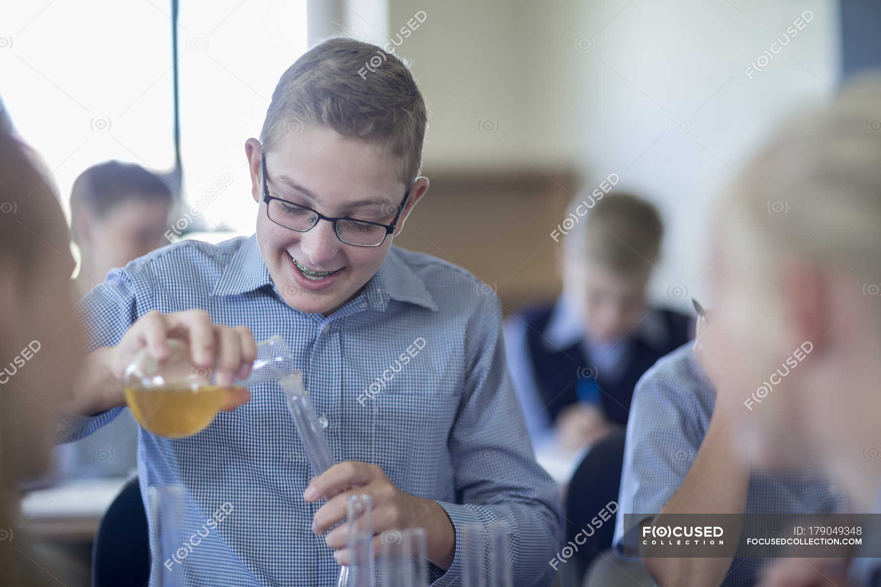 Boy Experimenting In Chemistry Class With Classmates Confidence 