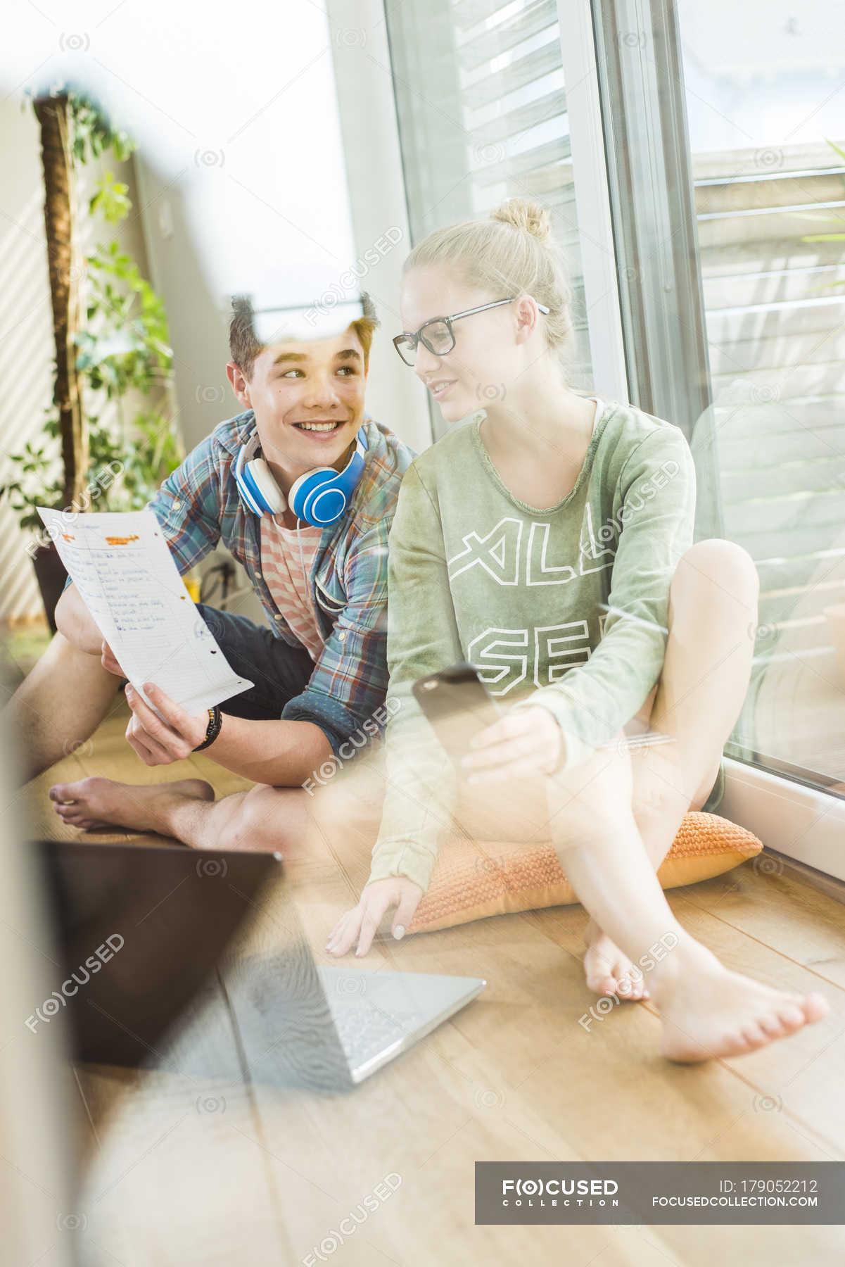 Two Caucasian Students Sitting On Wooden Floor Learning Young