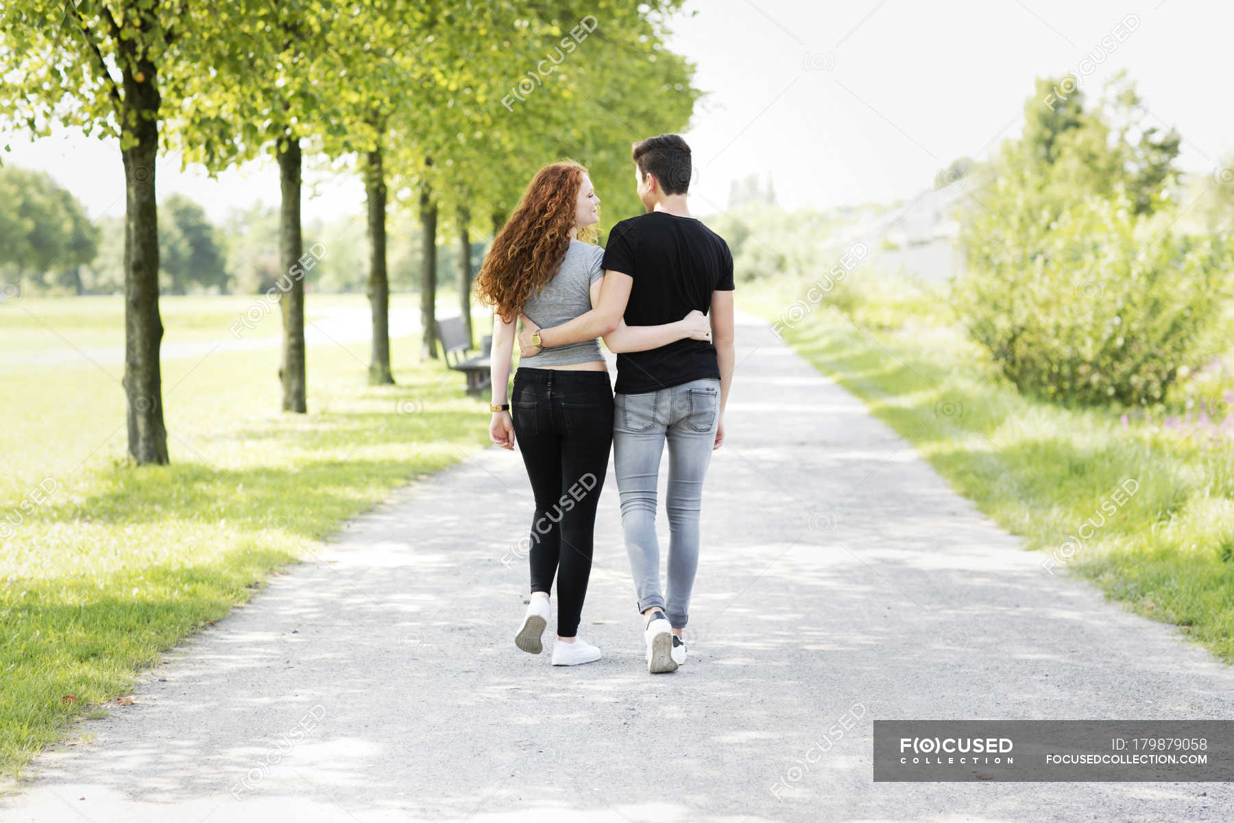 Teenage Couple In Love Walking Arm In Arm Two People Teenagers Stock Photo