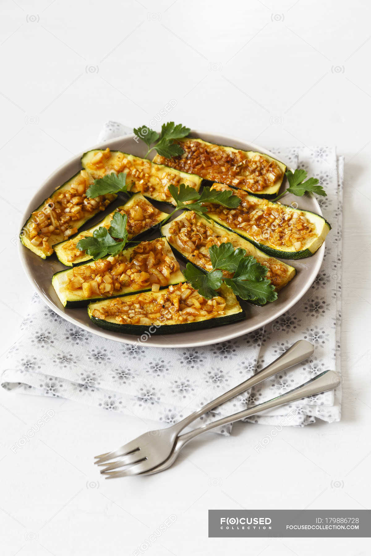 Gratinated sliced courgettes with Chermoula — leaves, knife - Stock Photo |  #179886728