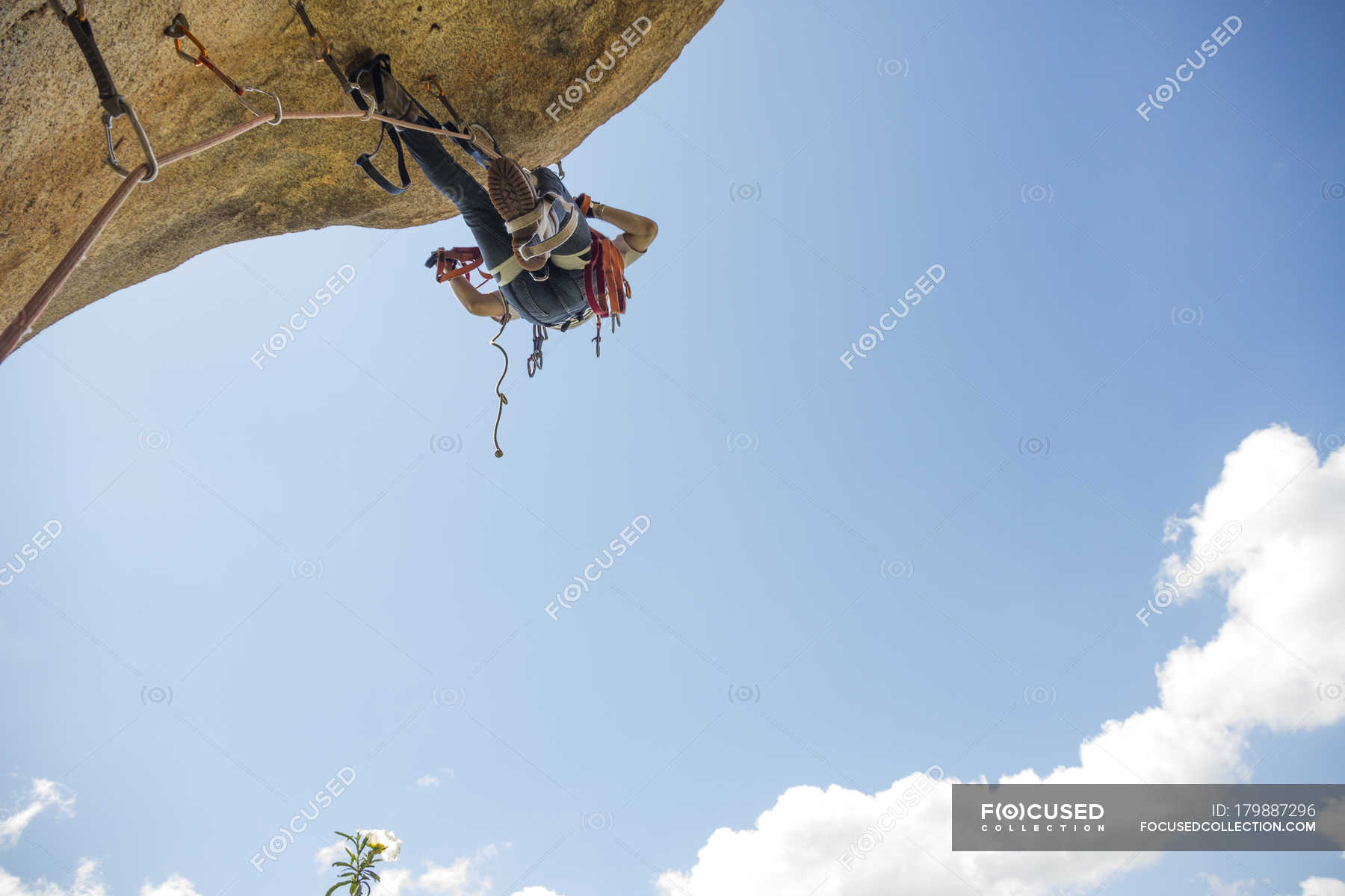 Climber climbing a rock using aid climbing techniques — challenge ...