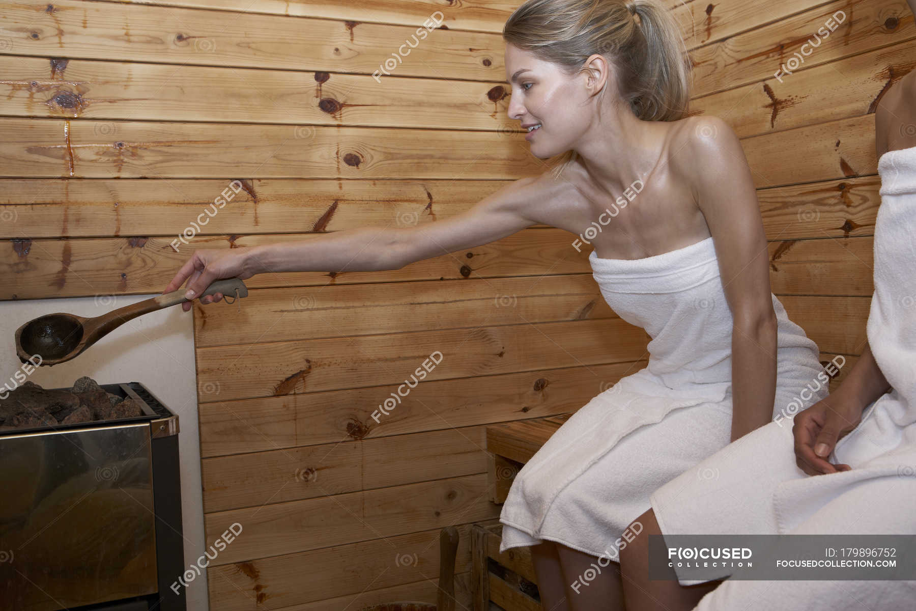 Two young women sitting in a sauna — 20 30 years, Casual Clothing - Stock  Photo | #179896752