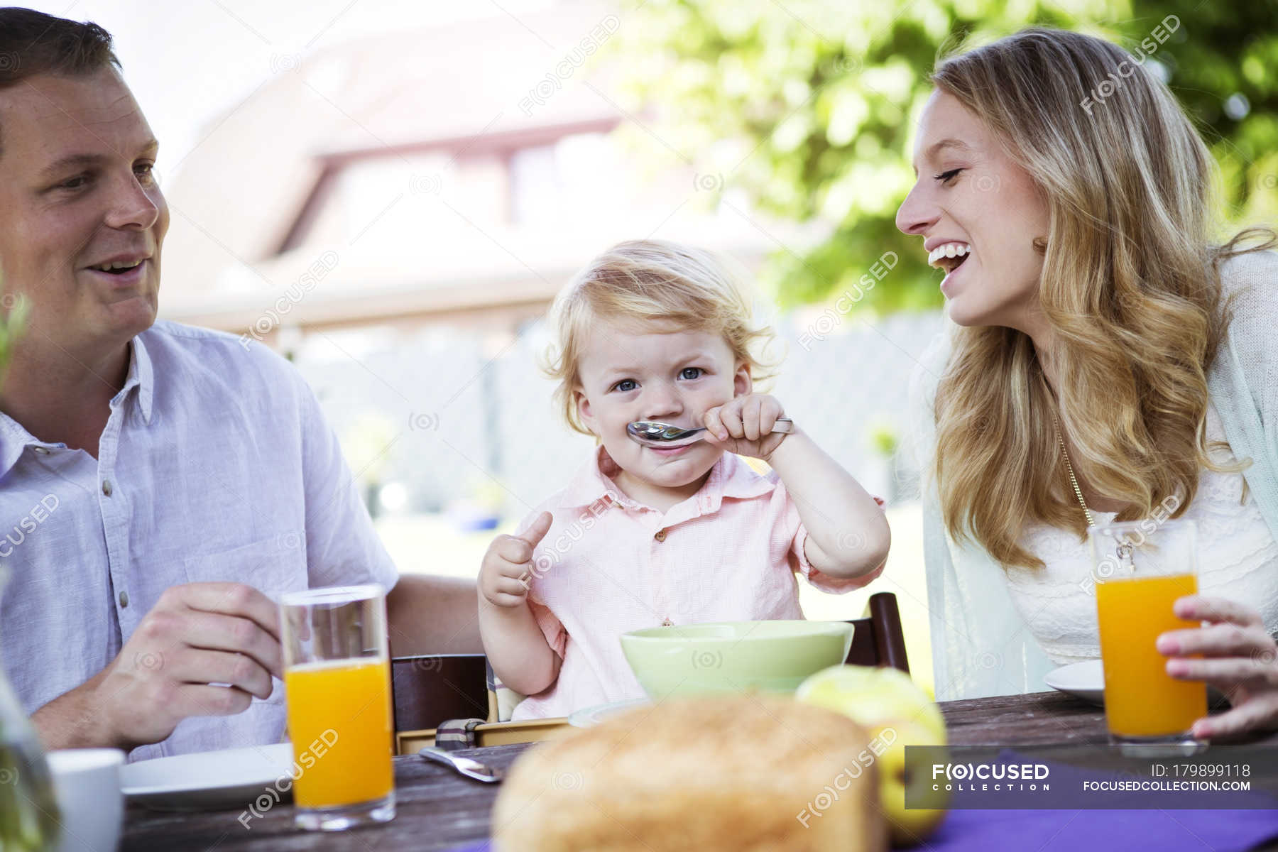 Happy family sitting at breakfast table — drink, bread - Stock Photo ...