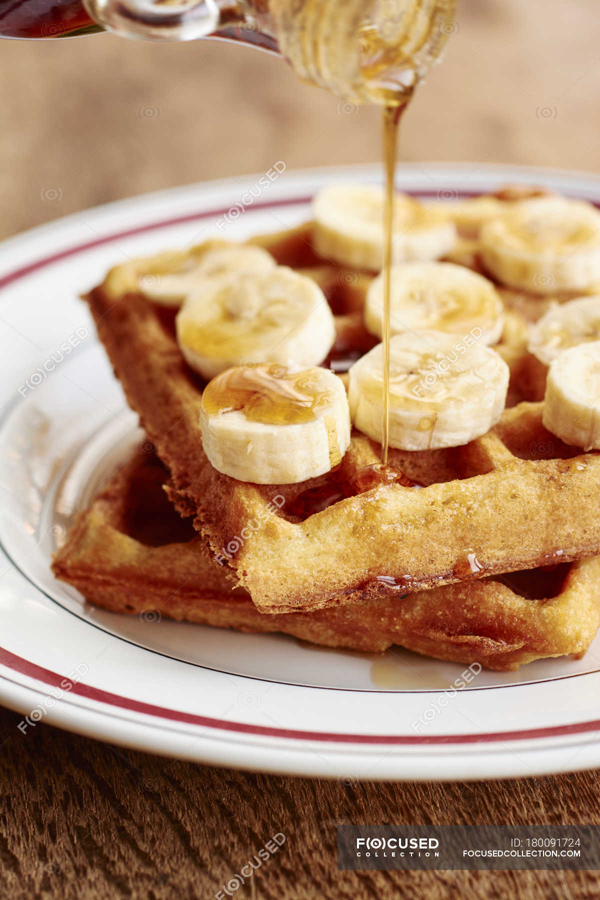 Puring Maple Syrup Over Quinoa Waffles With Banana Slices And Maple Syrup Plate Maple Sirup