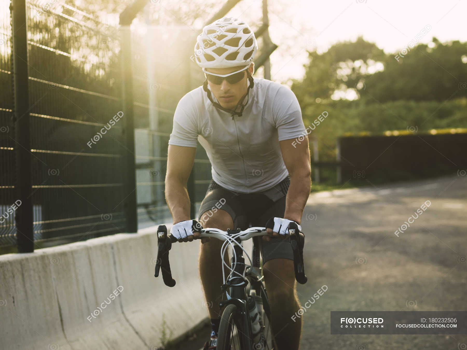 Racing biker wearing sunglasses and safety helmet — tricot, three quarter length Stock Photo