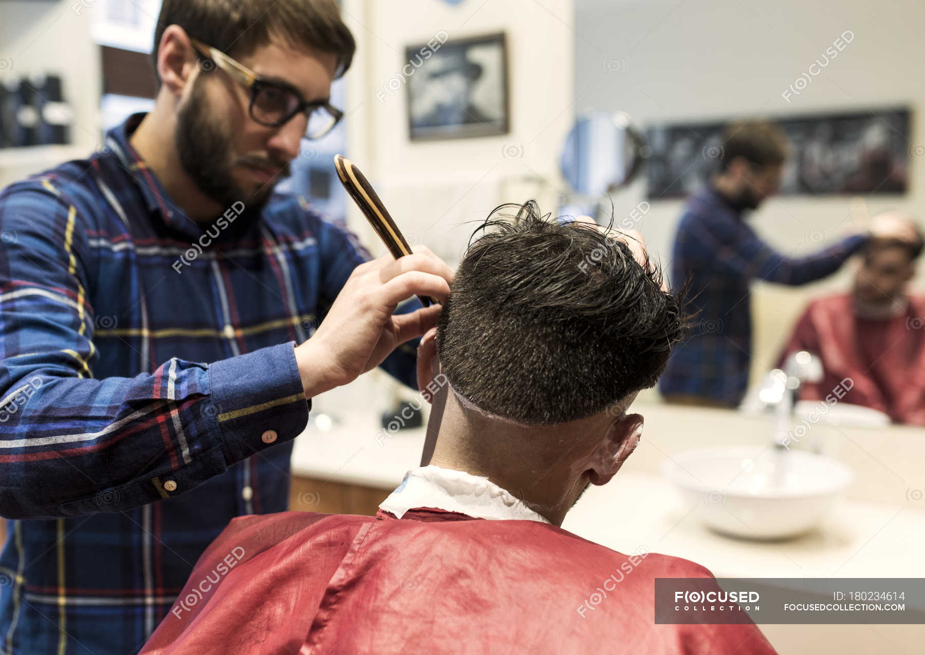 Hairdresser Shaving Young Man S Hair In A Barbershop Two People