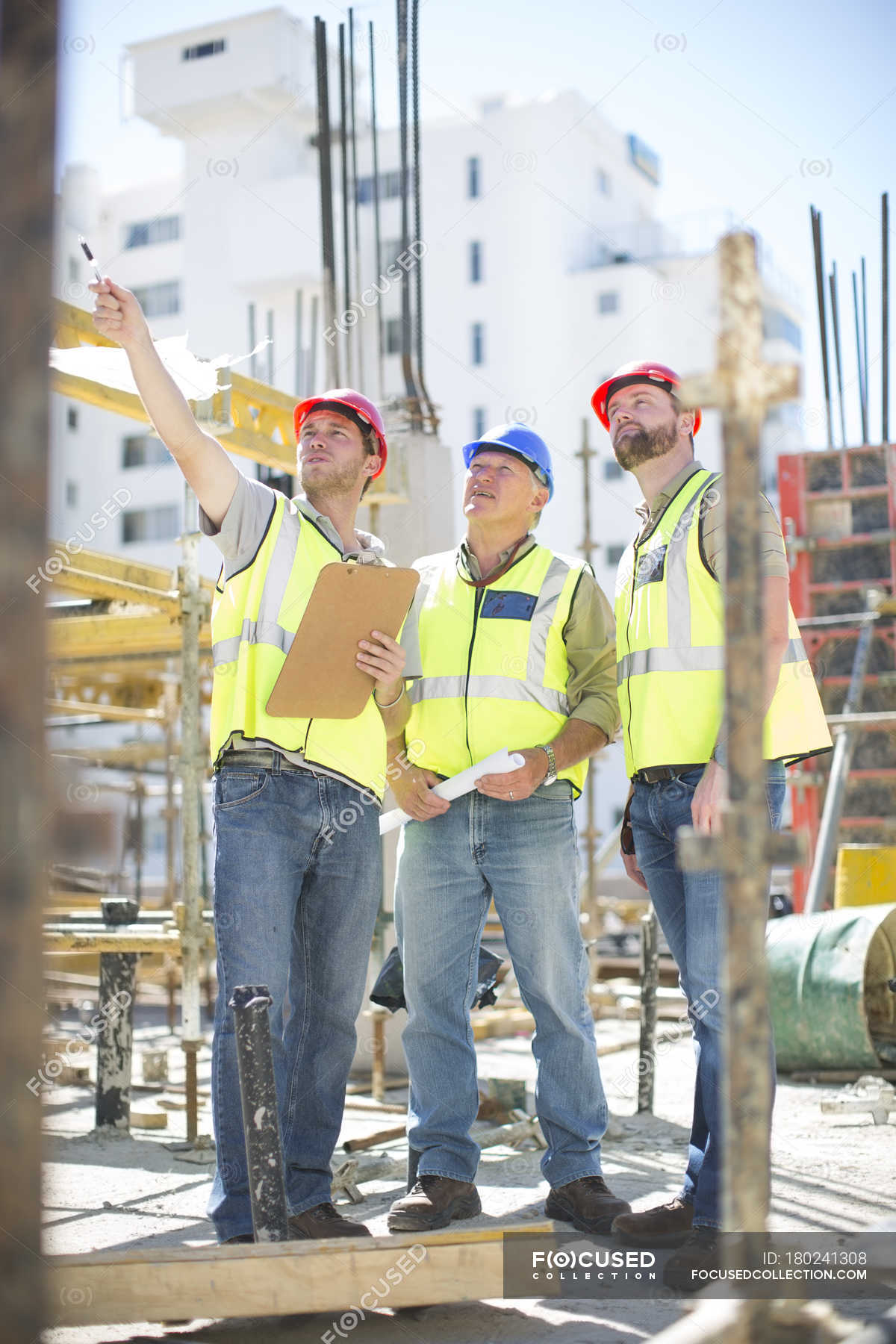 Three Construction Workers In Construction Site — Working Adults