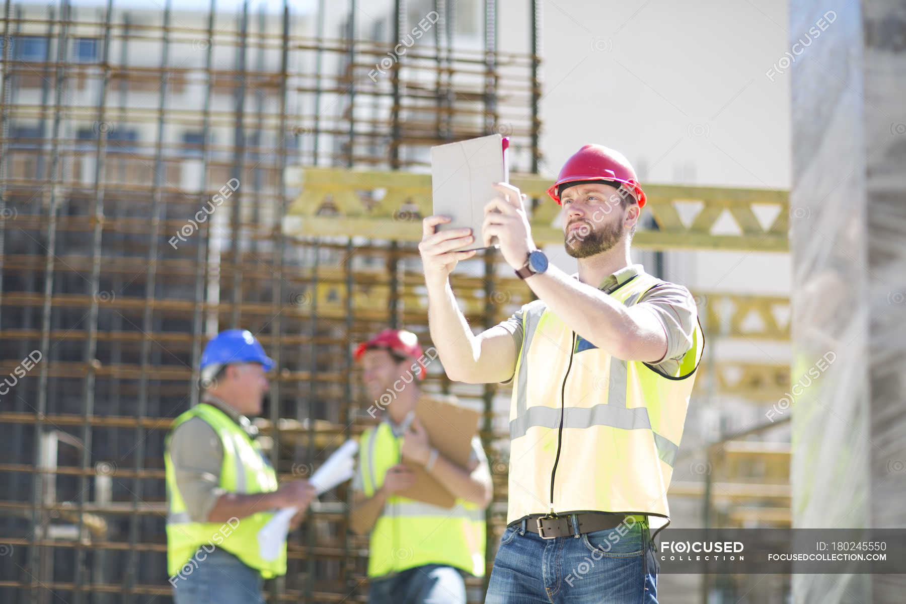 Construction Worker With Digital Tablet In Construction Site — Building