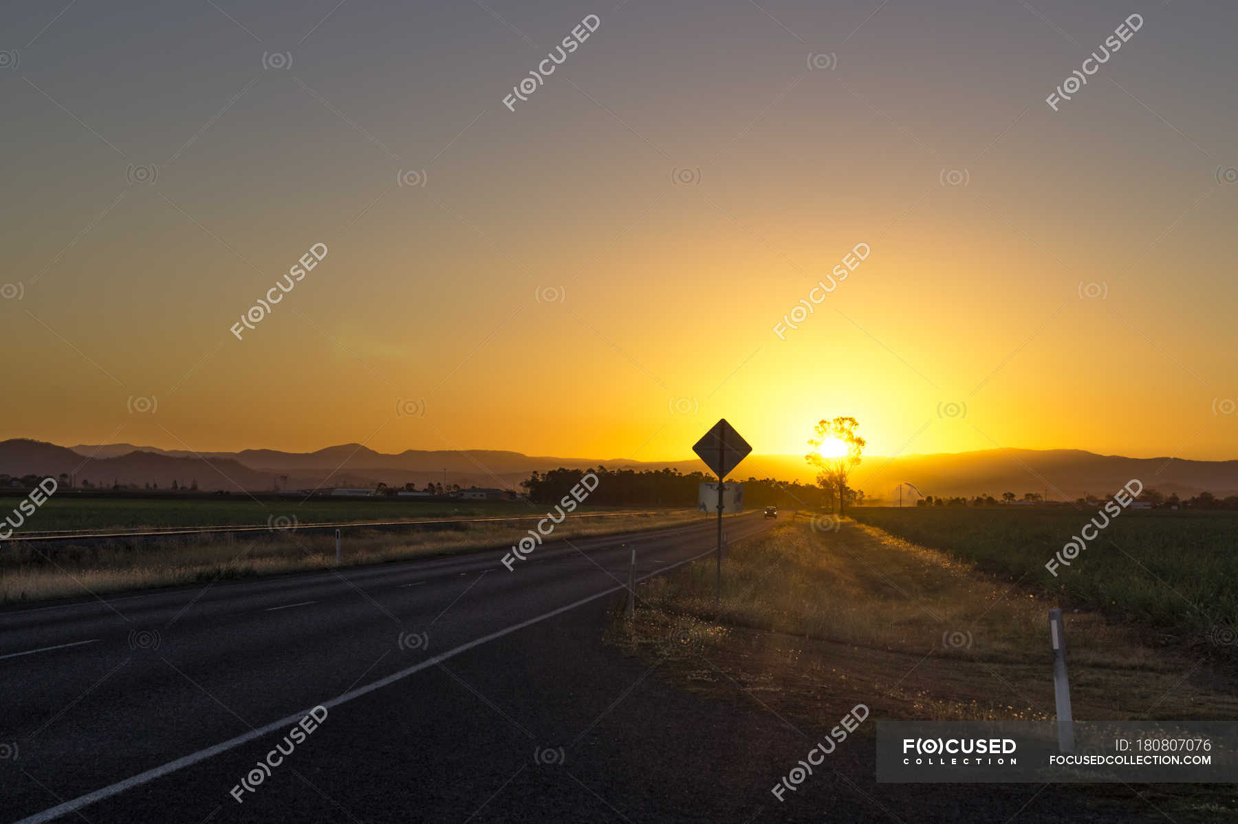 australia-queensland-road-with-mountain-chain-at-sunrise-motor