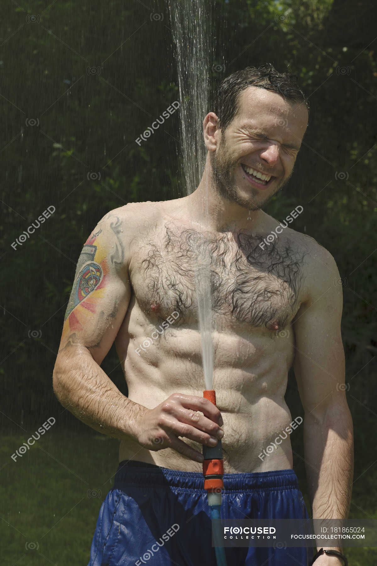 Young Man Taking Shower In Garden Smiling Color Image Toothy