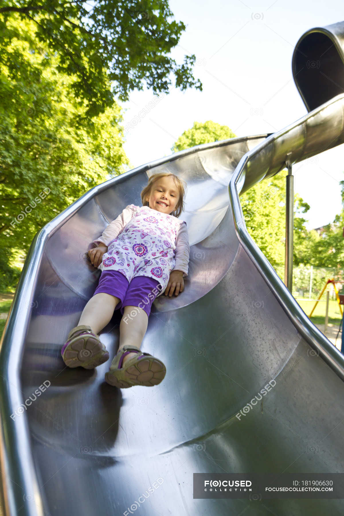 Happy Little Girl Sliding Fotolia