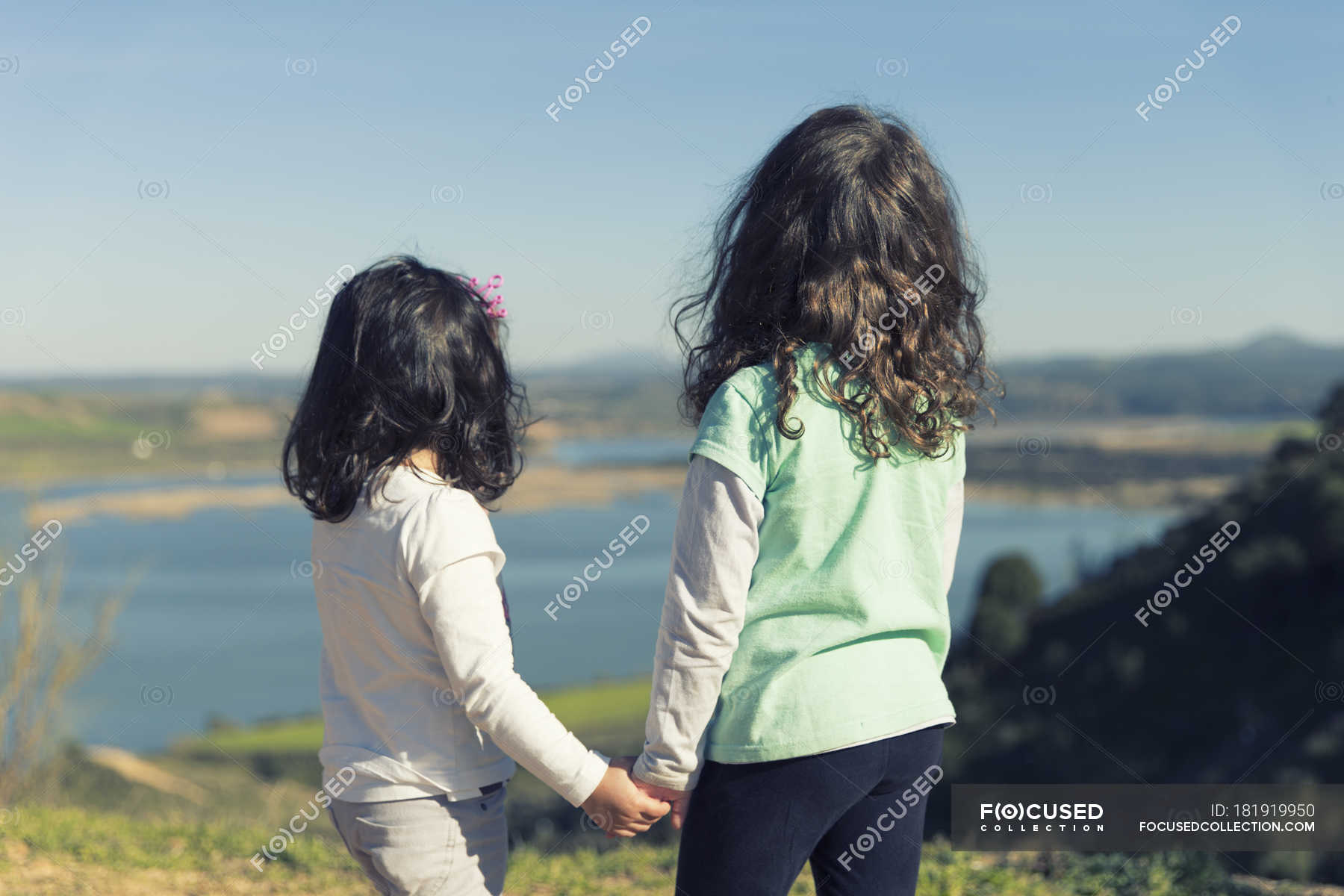 two little girls best friends holding hands