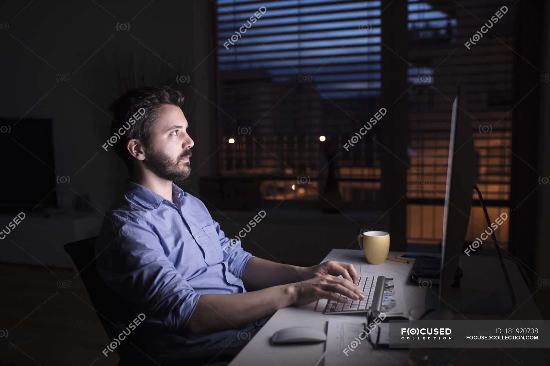 Slone night work. Working on a Computer at Night. Work with Computer at Night. Man working with PC at Night. Work late.