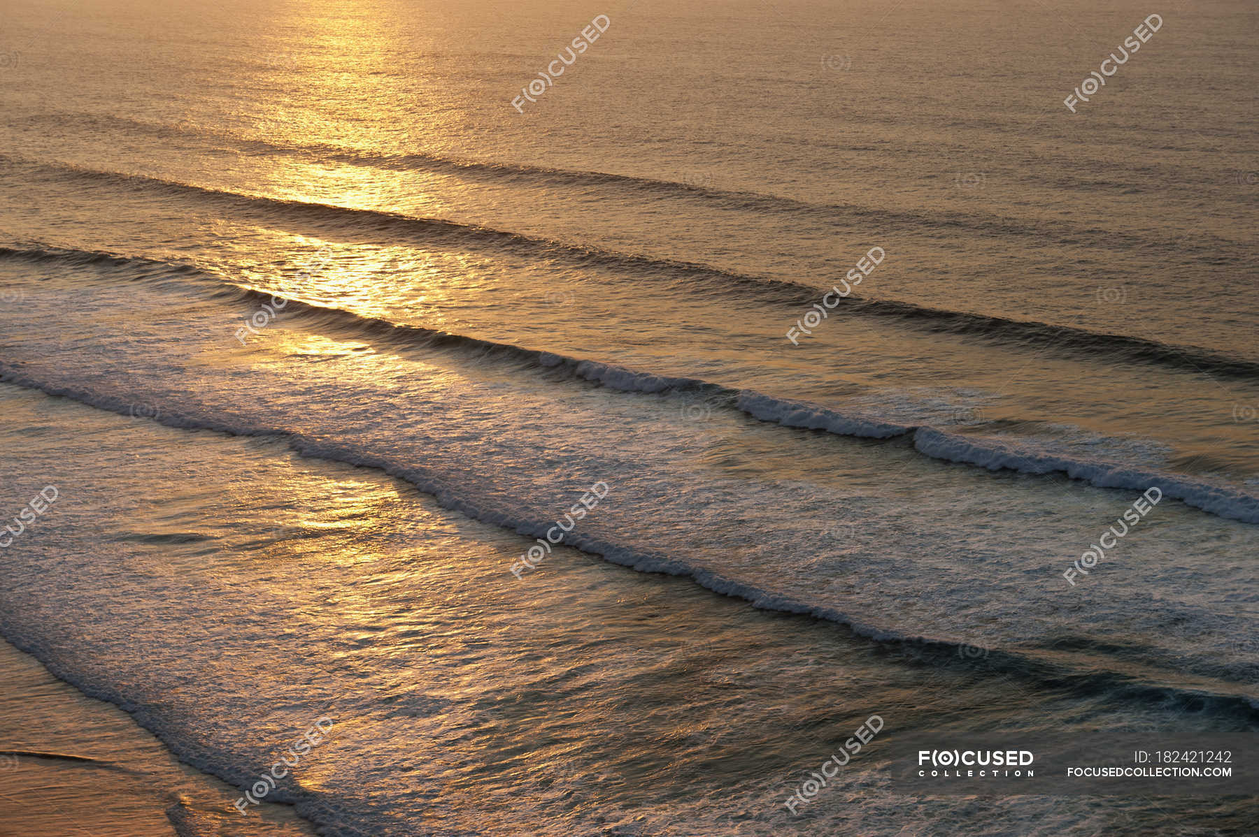sunset behind the sea waves paragraph