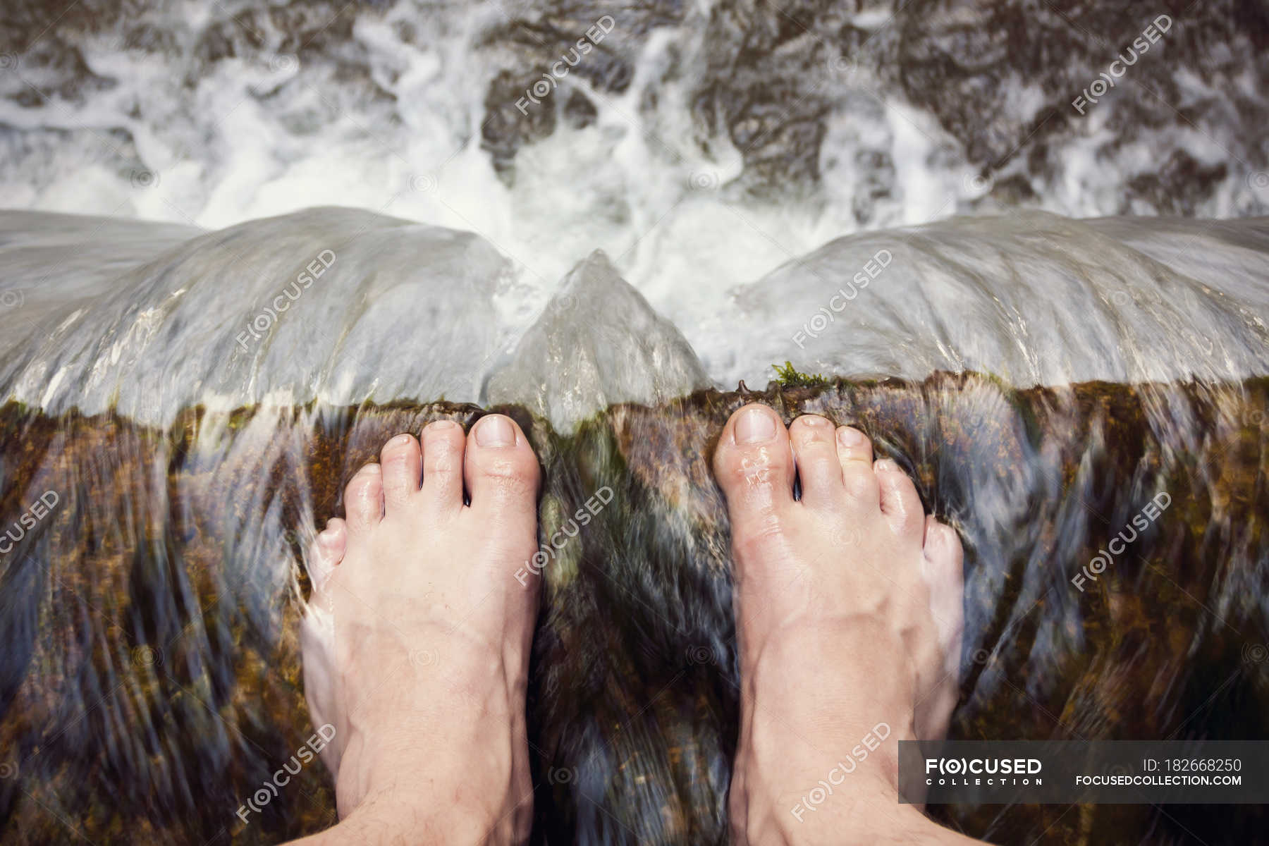 Barefooted Man Standing At Edge Of Waterfall Overhead Barefooted Man Standing At Edge Of