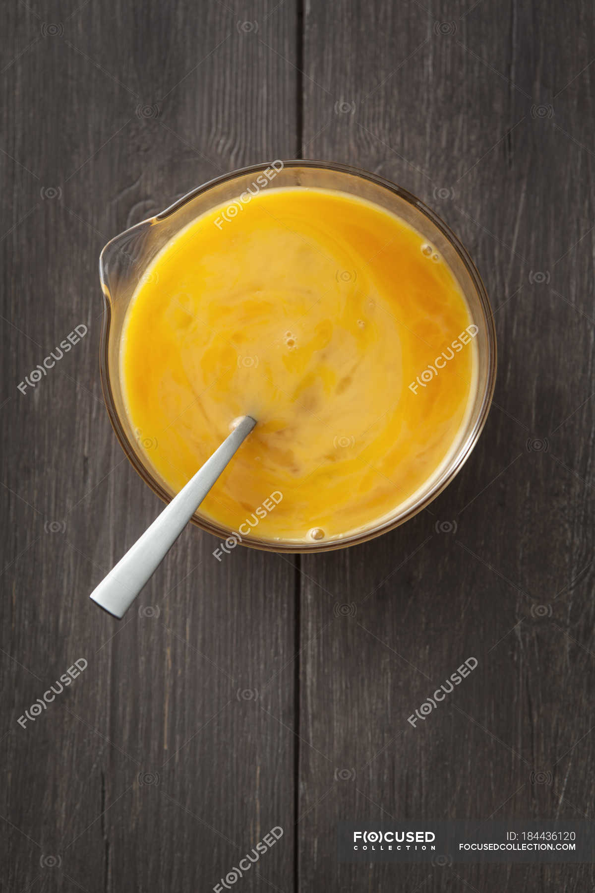 Scrambled eggs yolk in glass bowl on wooden table — Healthy Eating, Egg