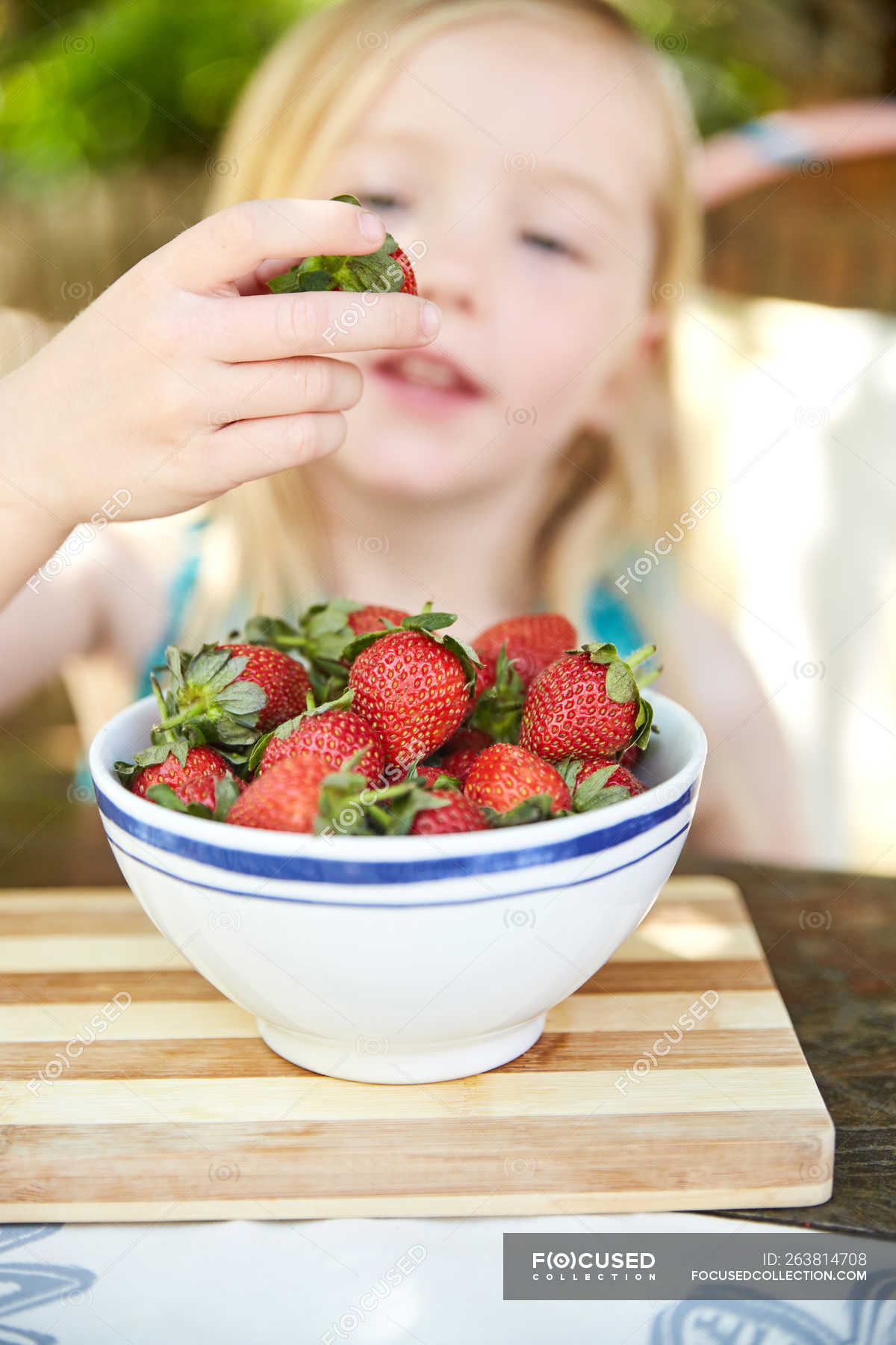 Girl Eating Strawberries Form Bowl Female Child Stock Photo
