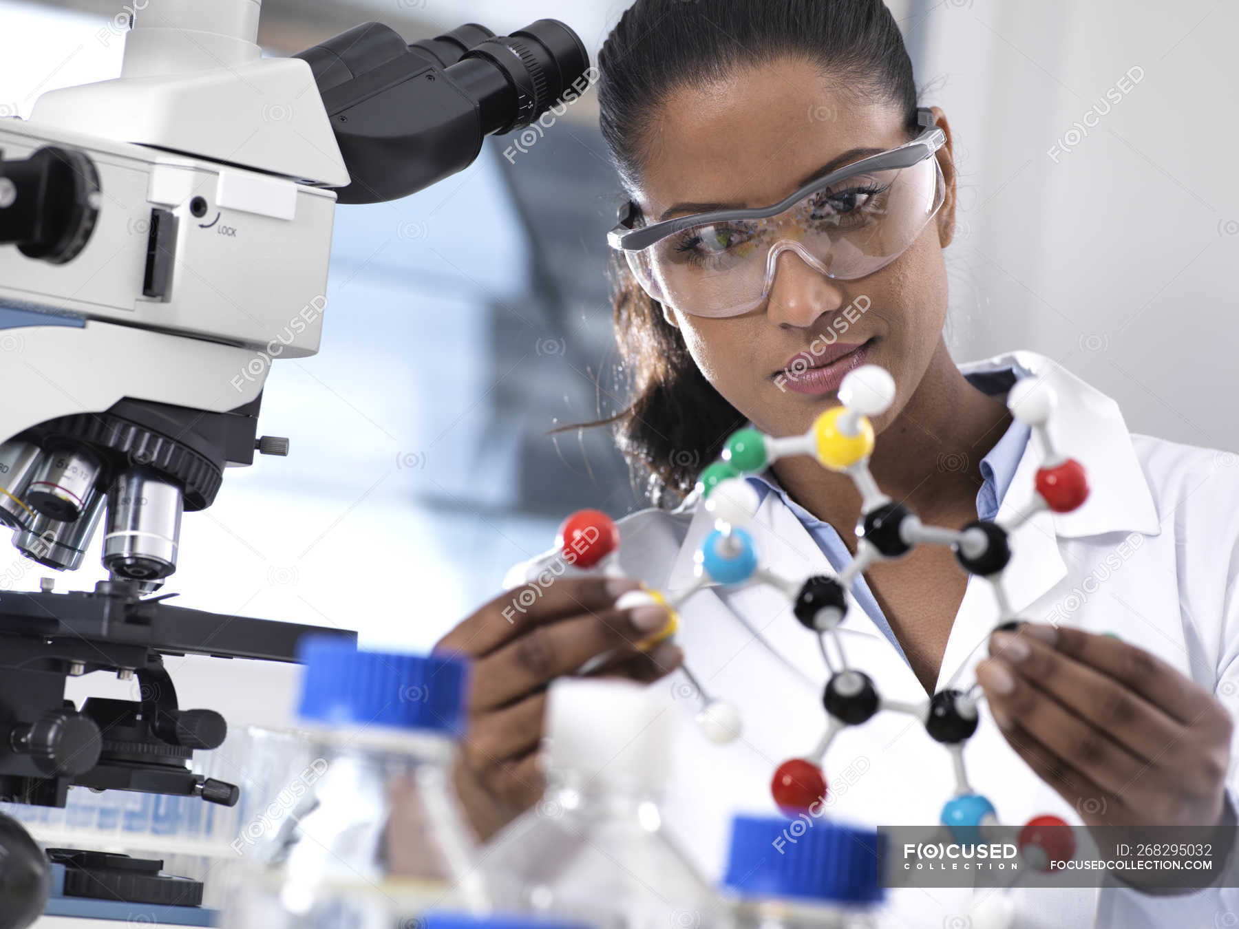 Biotechnology Research, female scientist examining a chemical formula