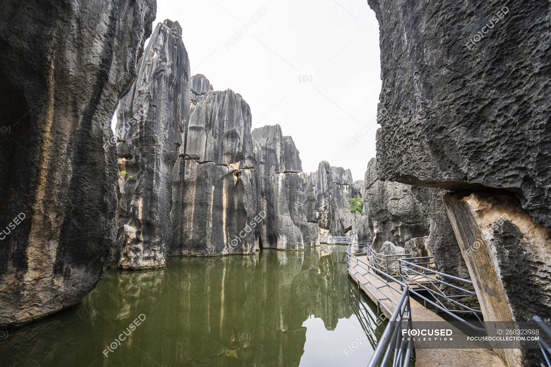 China, Shilin, Stone forest, lake and path — outdoors, rocky - Stock ...