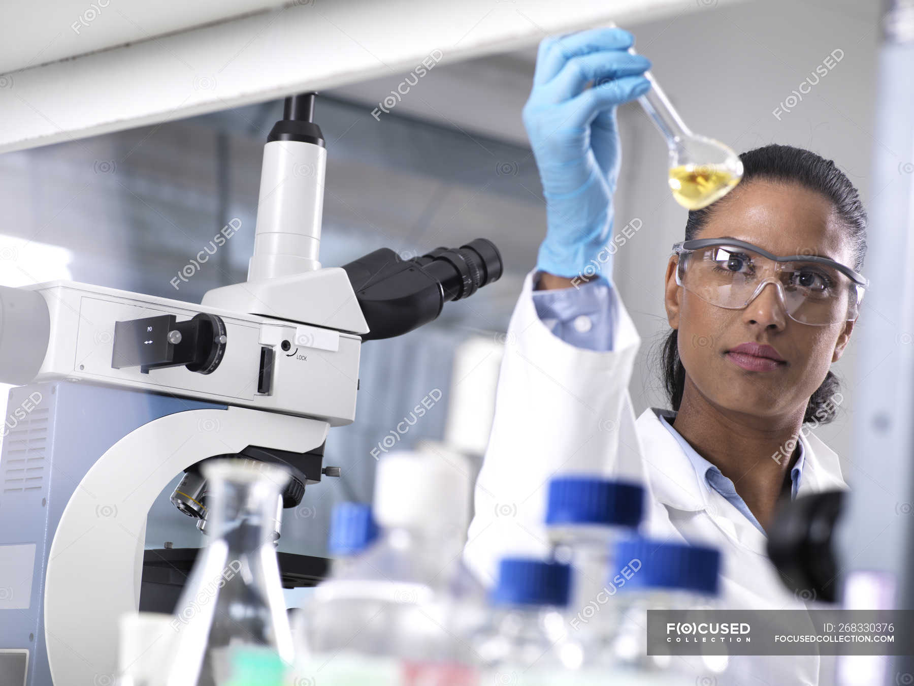 Biotechnology Research, female scientist mixing a chemical — workplace, control - Stock Photo | #268330376