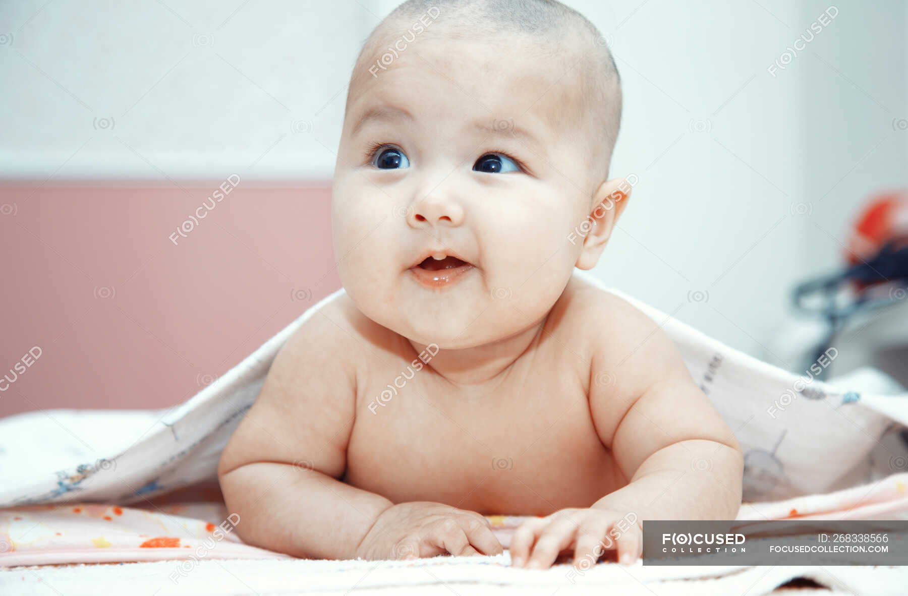 Smiling Baby Lying Naked On Bed Portrait Head And Shoulders Months Stock Photo