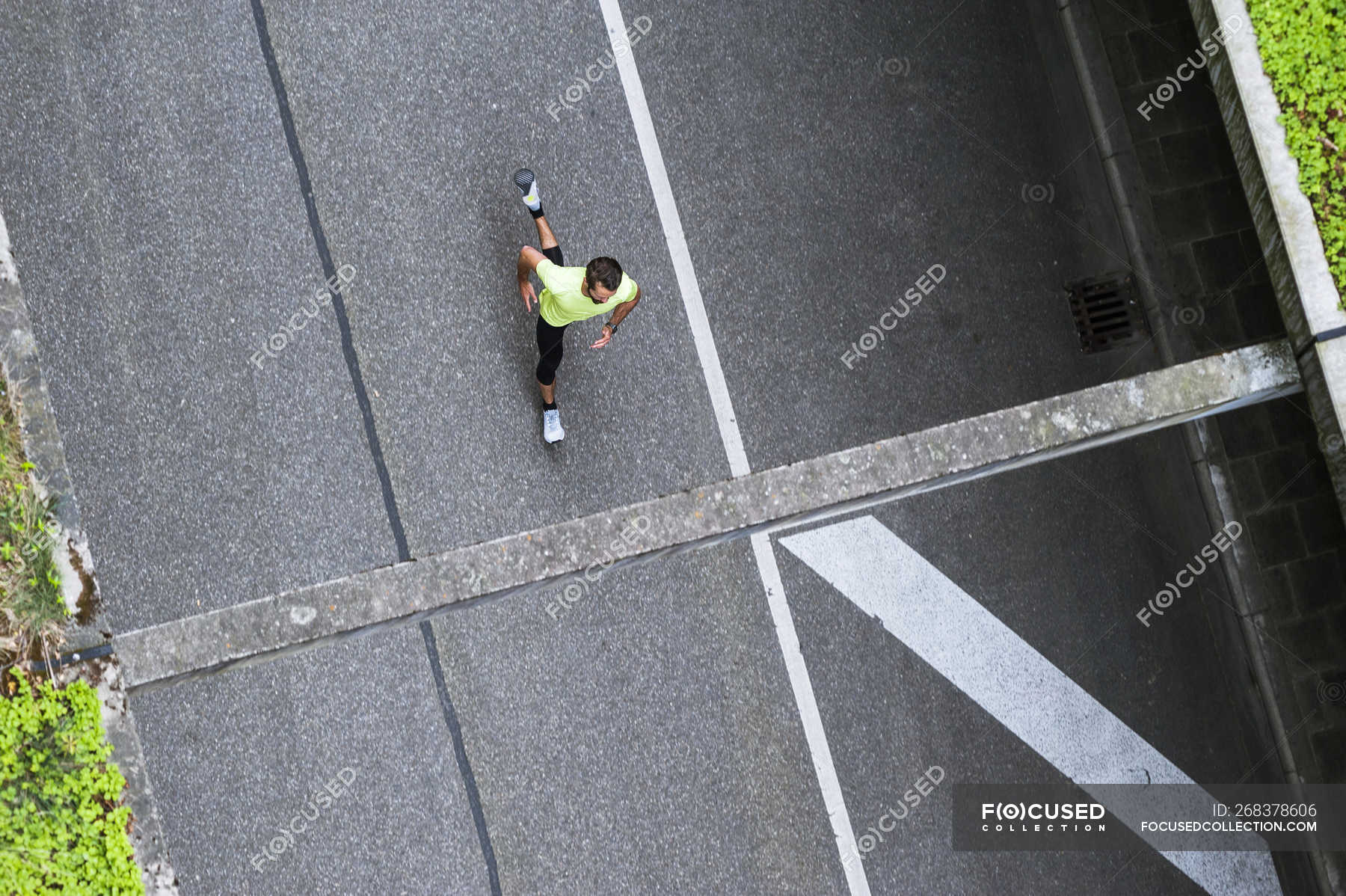 Top view of man running on a street — endurance, fitness training