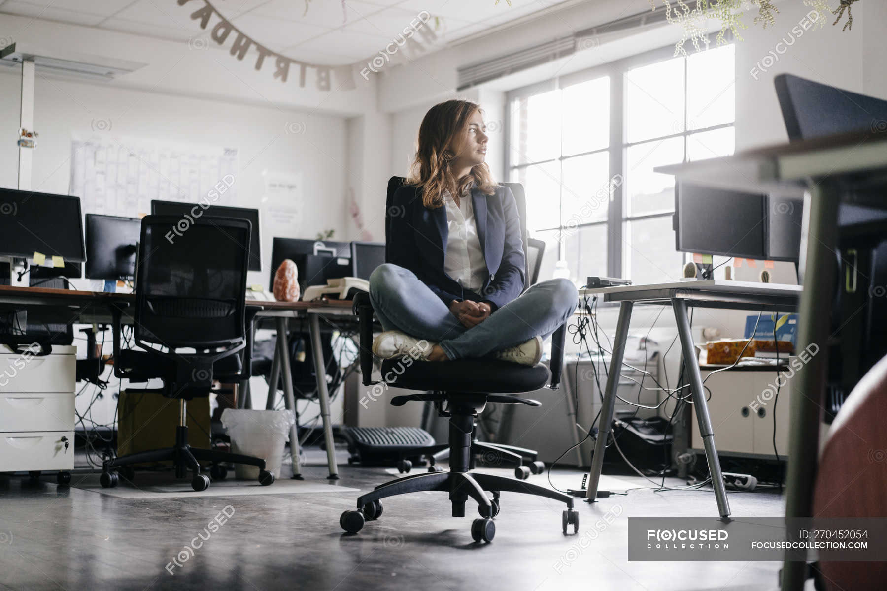 Businesswoman sitting cross-legged on office chair — female, Business  People - Stock Photo | #270452054