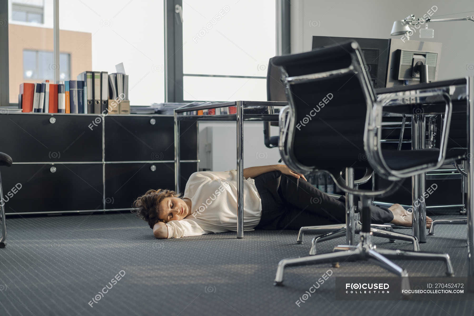Tired Businesswoman Sleeping On Floor Under Her Desk Caucasian