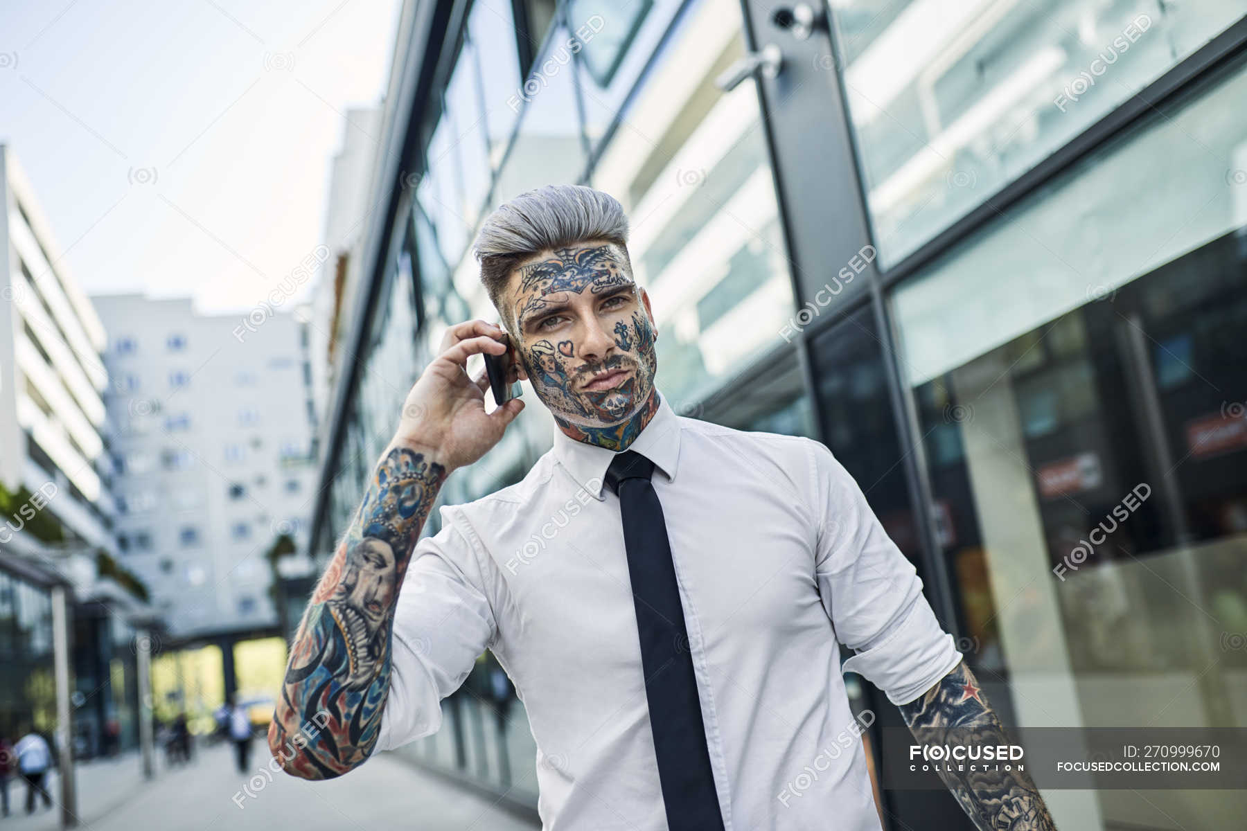 Young businessman with tattooed face portrait stock photo  OFFSET