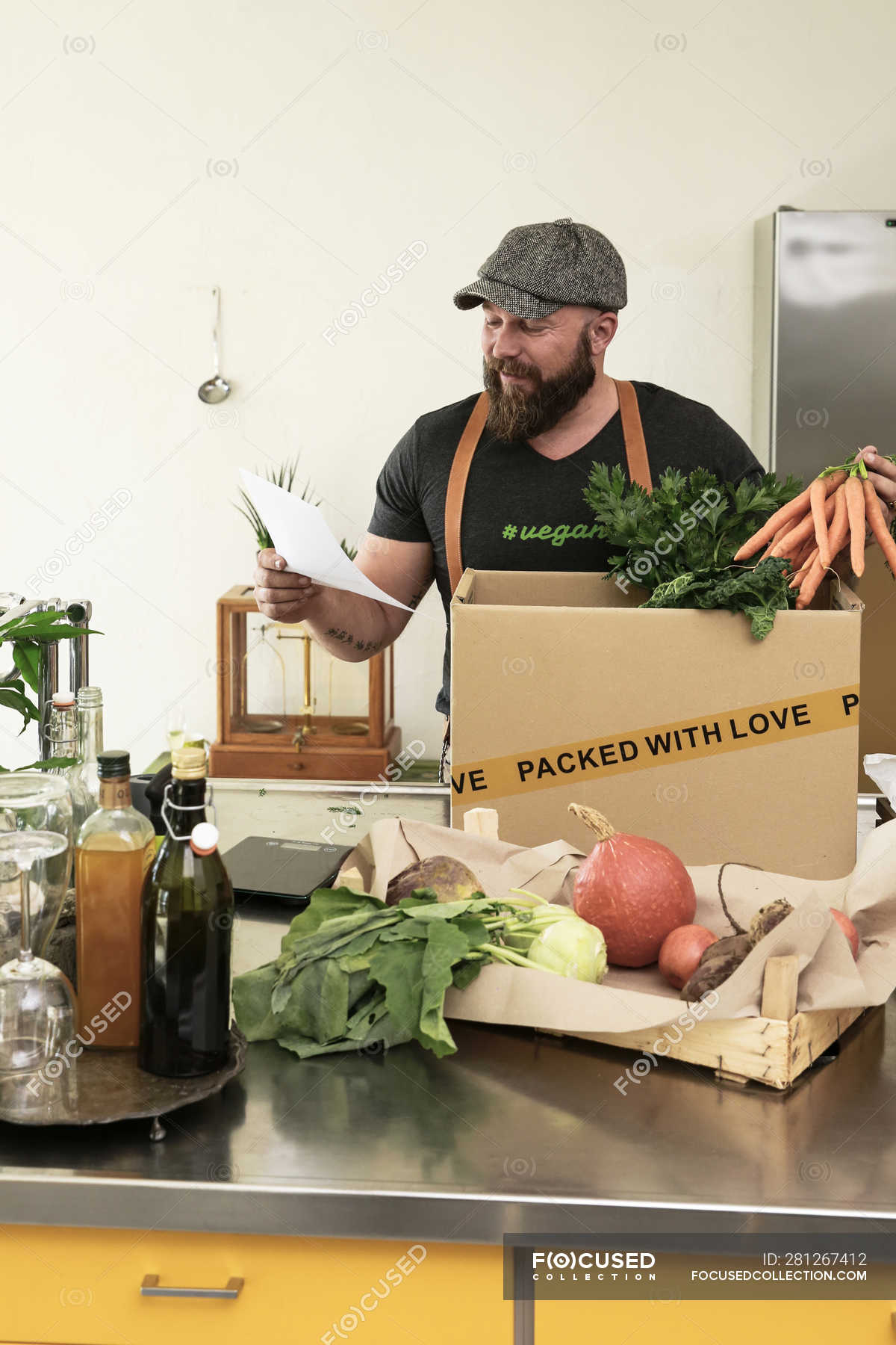 Mature Man With Delivery Service Packing Organic Vegetables In