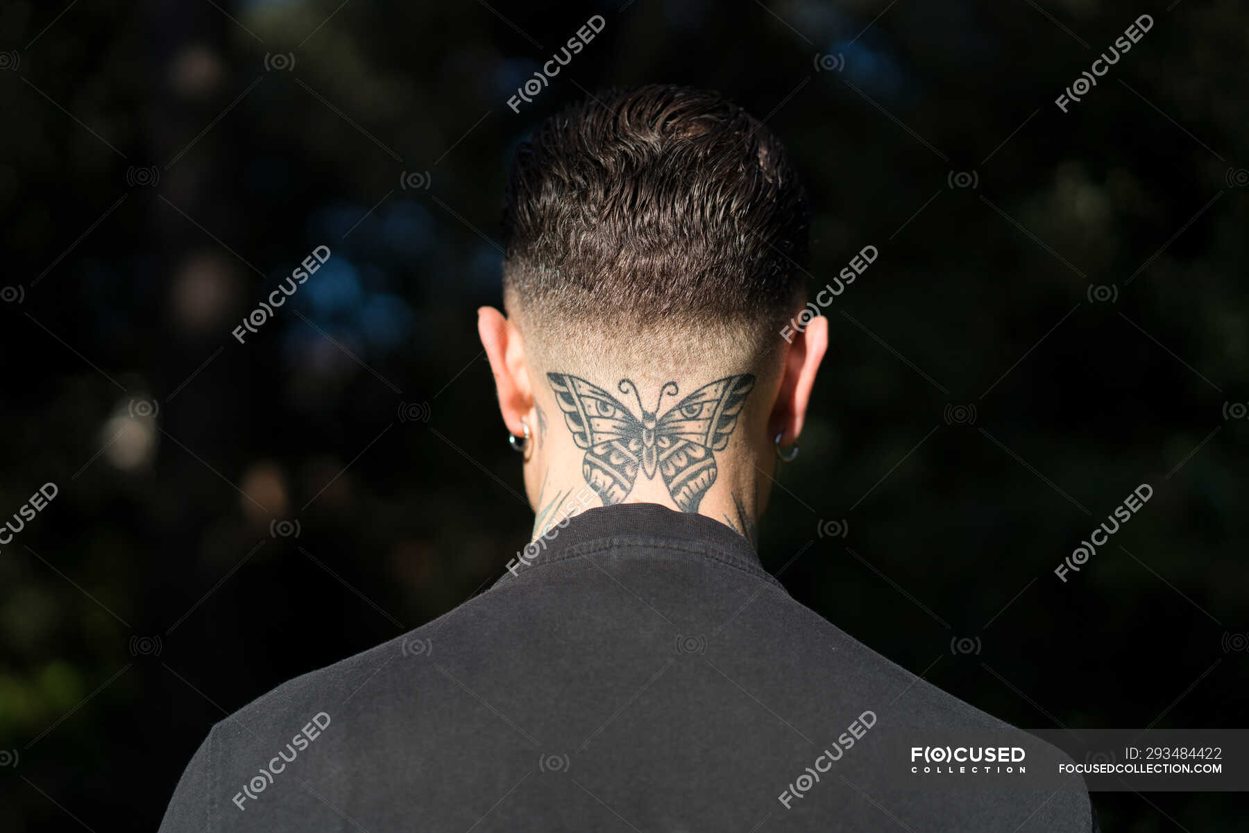 Back view of man with tattooed butterfly on his neck  individuality high  contrast  Stock Photo  293484422