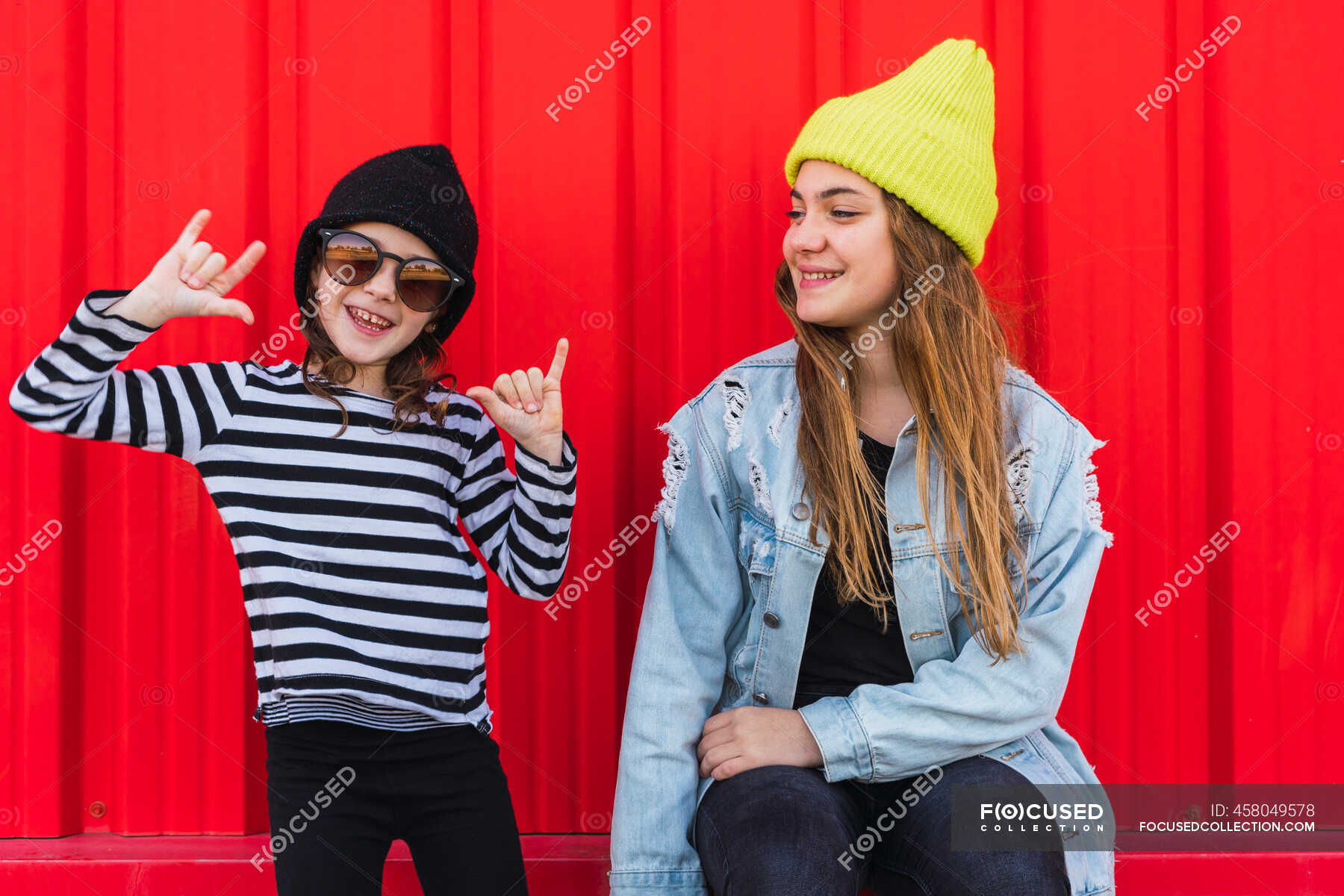 portrait-of-teenage-girl-having-fun-with-younger-sister-cheerful