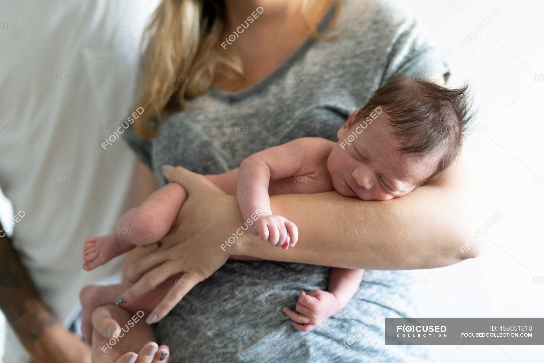 Parents Holding Their Nude Newborn Baby Innocence Close Up Stock