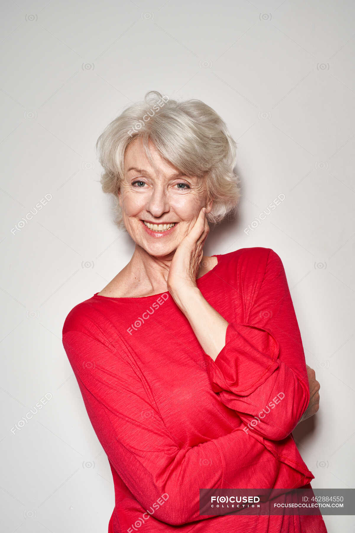 Portrait of smiling mature woman red pullover — person, leaning Stock Photo | #462884550