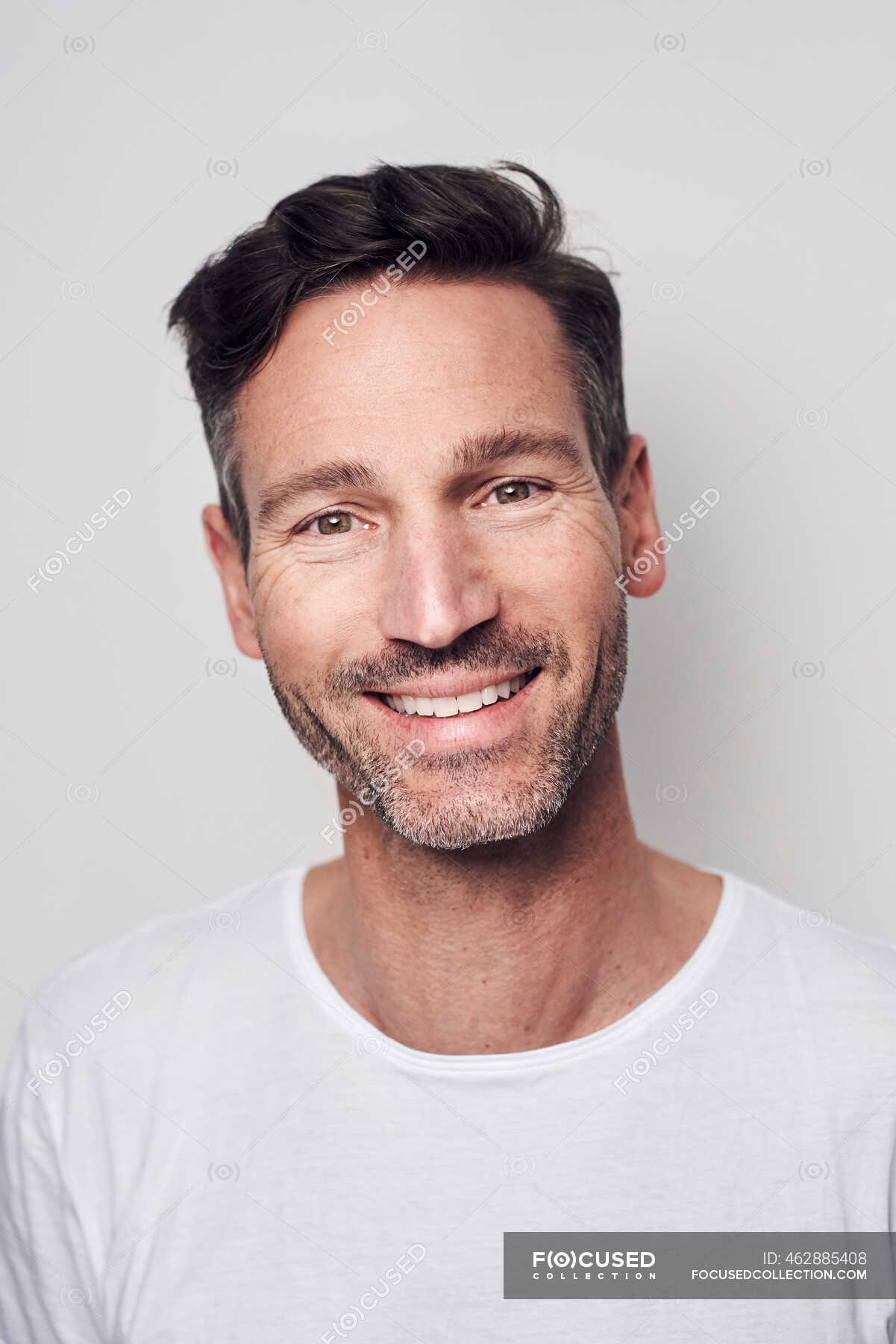 portrait-of-man-wearing-white-t-shirt-indoors-confidence-stock